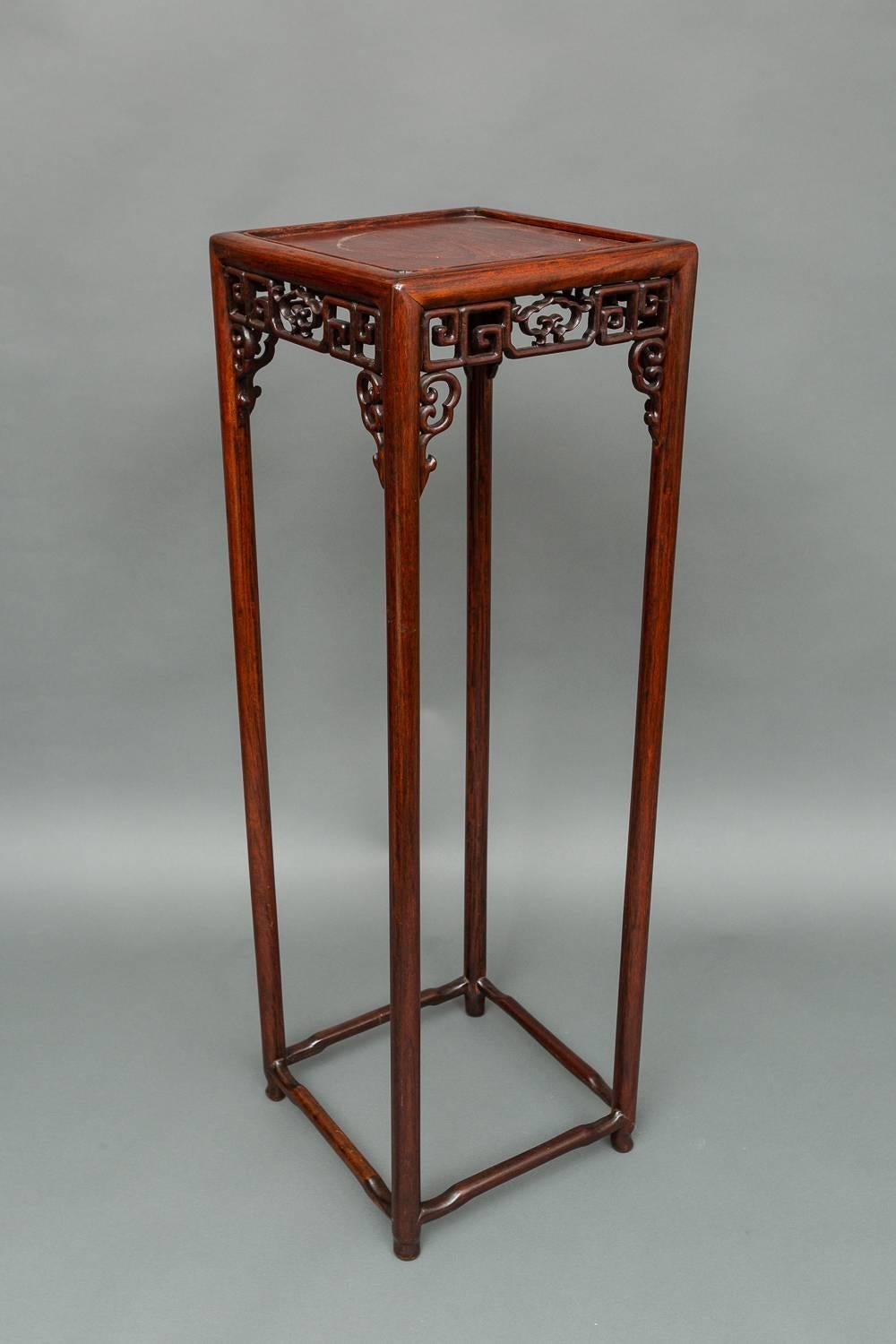 Chinese 19th century tall stand with fretwork apron.