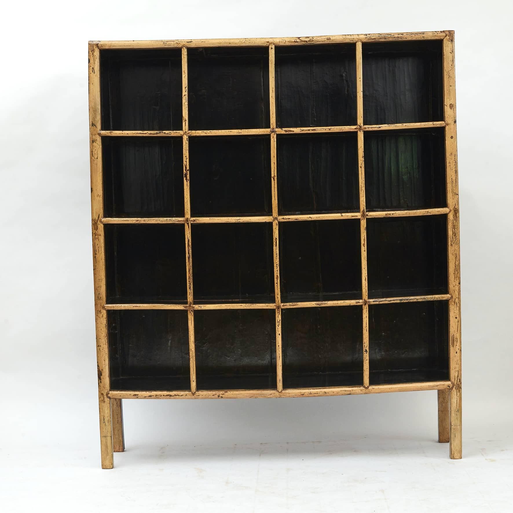Bookcase made from solid elmwood and covered in a light yellow lacquer on the outside and black lacquer on the inside.
Natural age-related patina and charisma.
China 1880-1900.
 