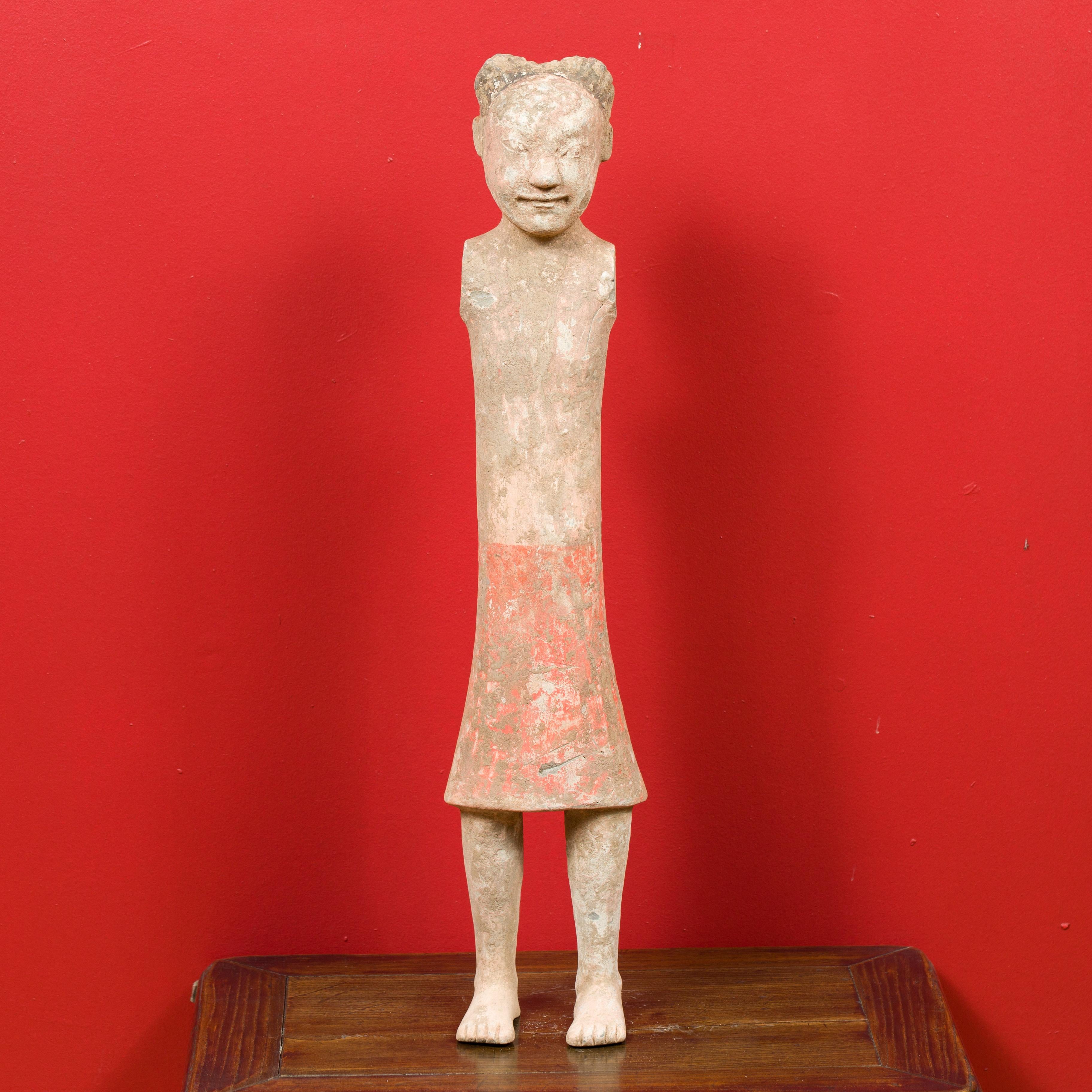 A Chinese Western Han dynasty period armless figurine with parted hairdo, long skirt and original polychromy. Born in China during the Western Han dynasty (206 BC-24 AD), this bare-chested and armless figurine features a surface showing its original