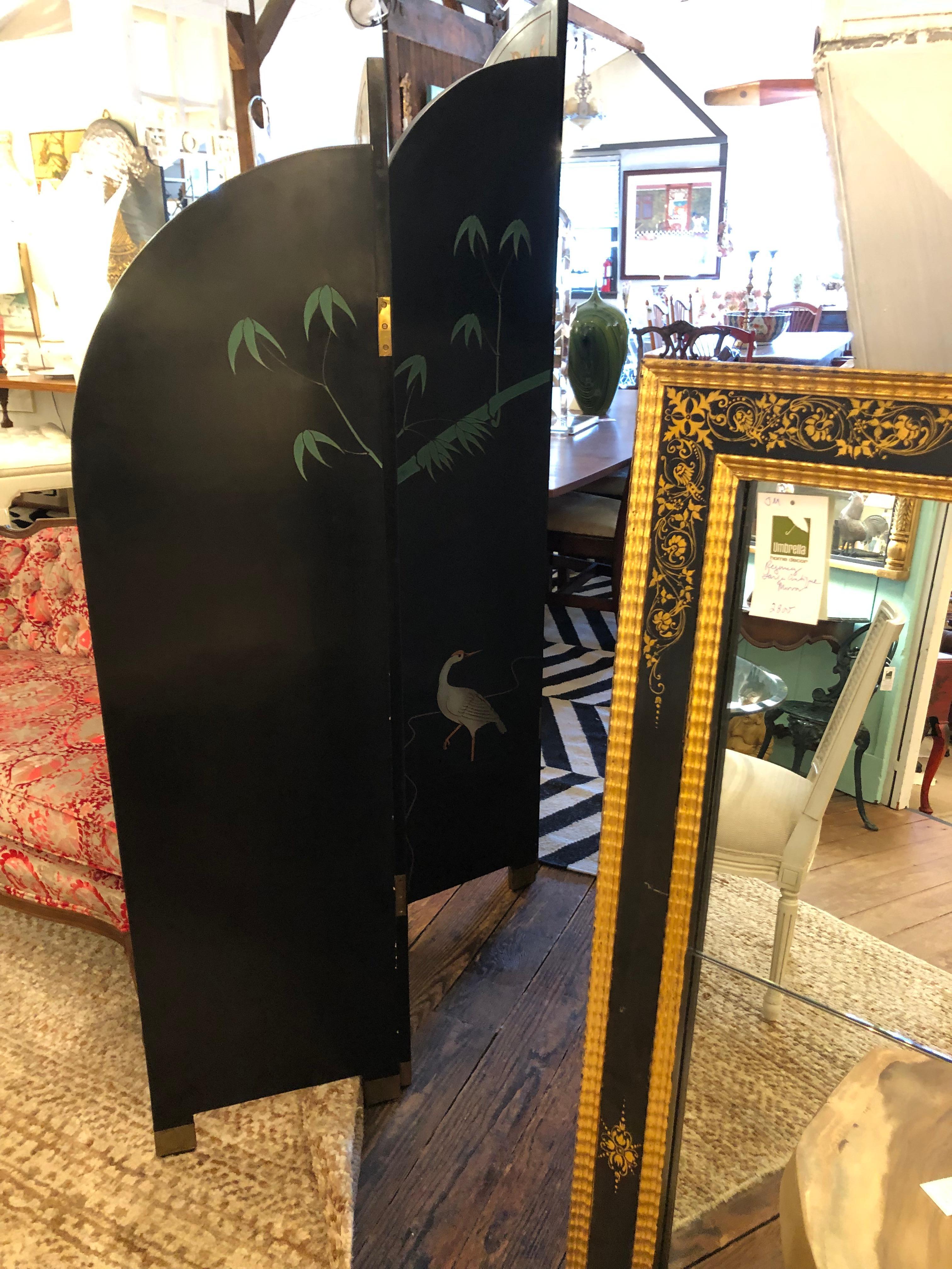 Unusual and lovely 4 panel Asian black laquer screen where each panel is a different height.  Beautiful carved and painted decoration of birds and dogwood flowering branches, front and back. The brass feet are a nice touch.

Each panel is 16