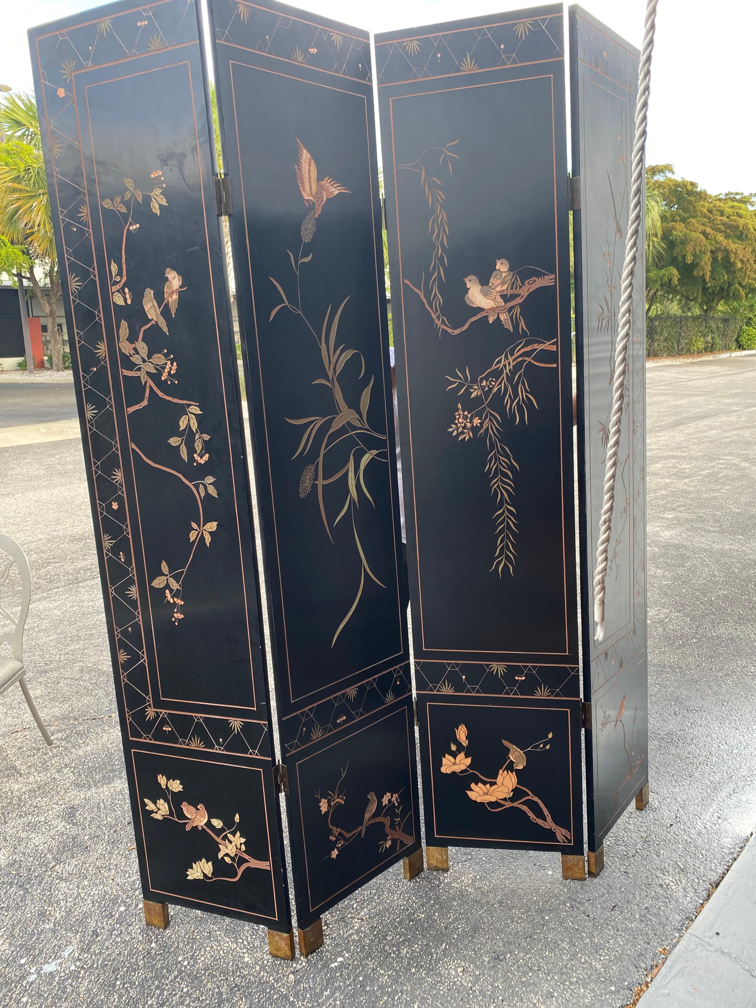 This four panel Coromandel Screen is a pleasure to look at having been hand crafted and edged painted and gold leaf with a center design showing off the gold leaf and flowers, etc. surrounding the design.