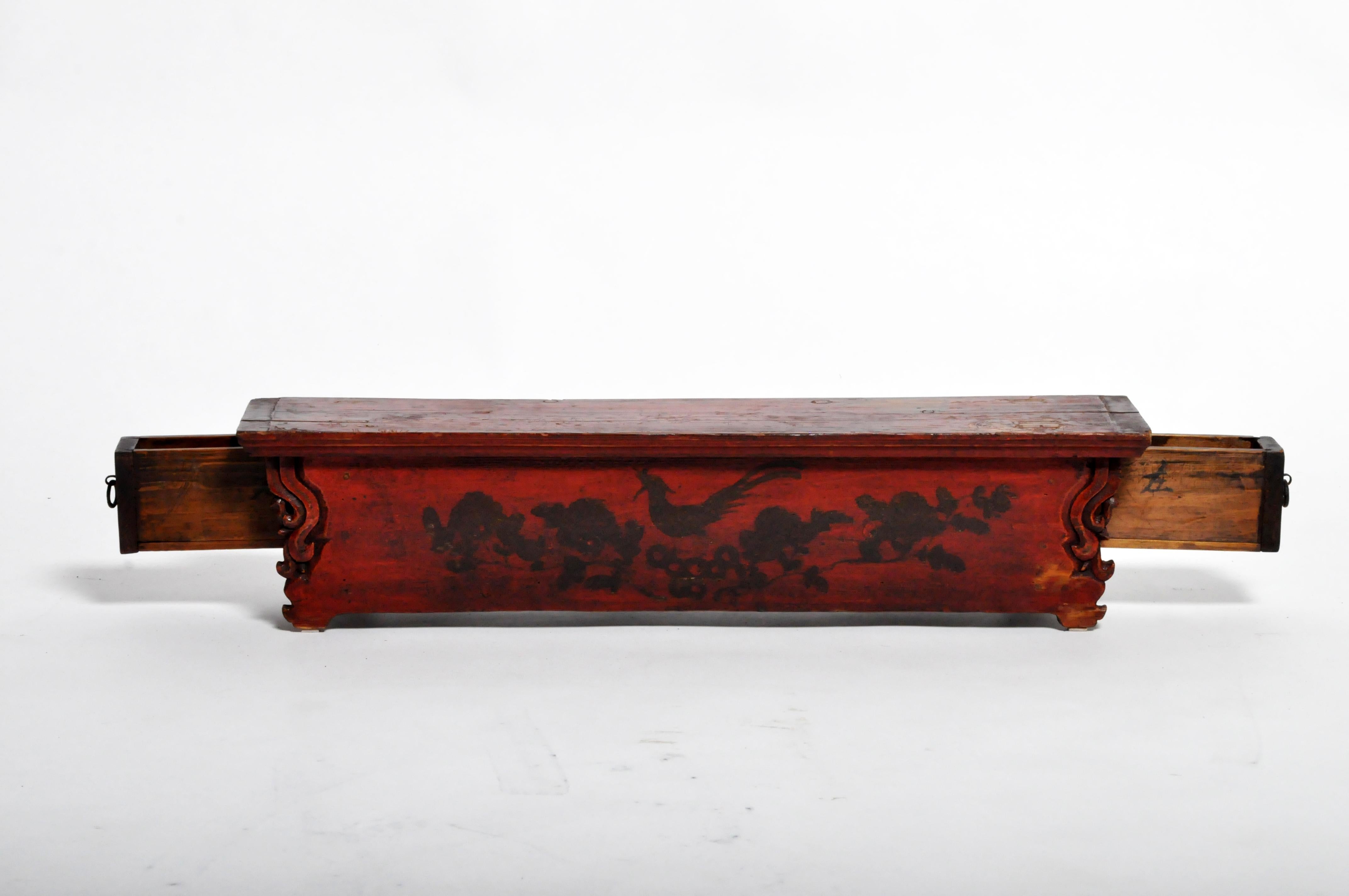 This small Fir Wood stand held sculptures, vases, and ritual objects. It was finished in oxblood-colored lacquer and decorated with a small painting depicting birds and flowers. Each end conceals a drawer for incense sticks. The piece dates to the