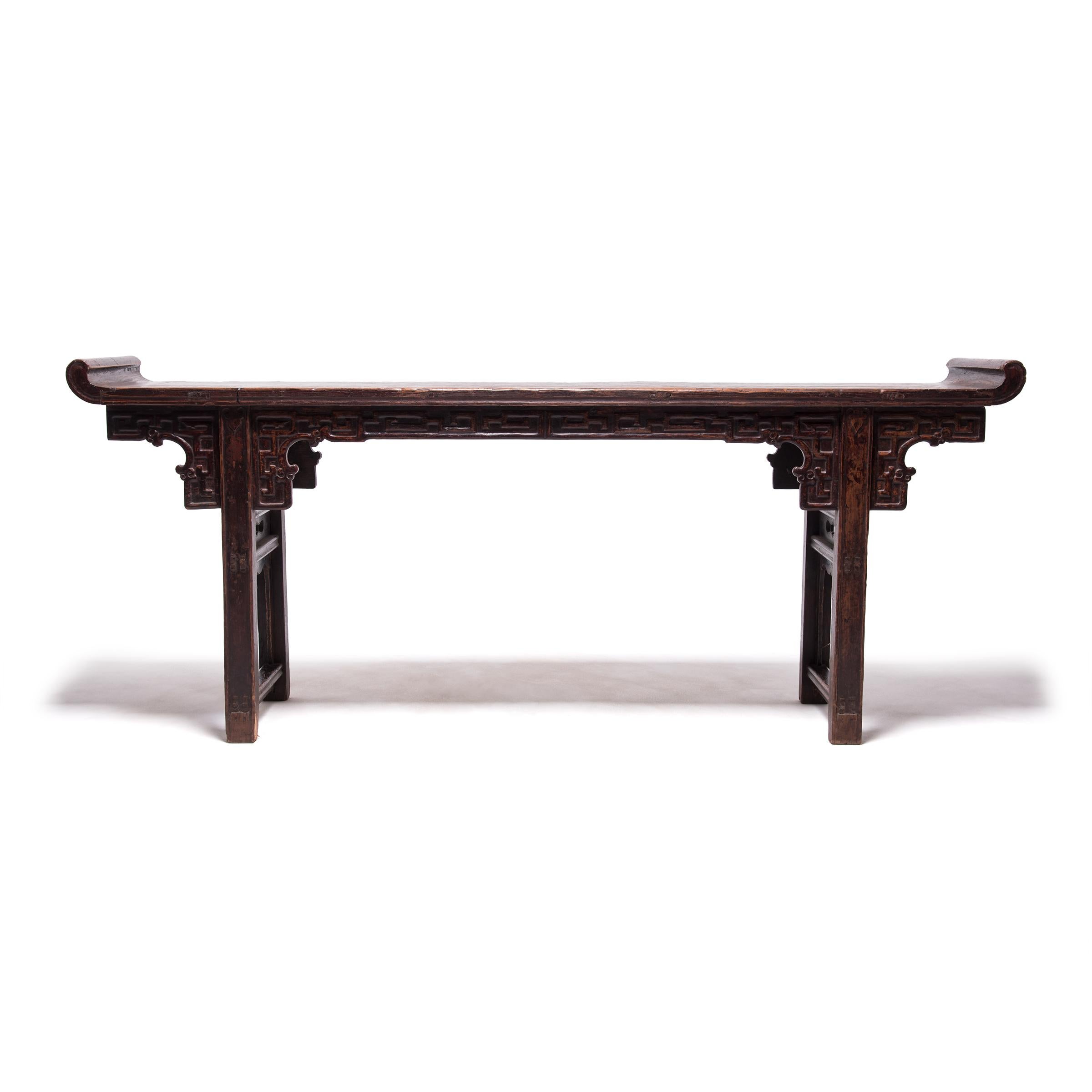 In traditional Chinese homes, slender, long tables such as this one are used to hold musical instruments, flowers, or vases. Often referred to as altar tables, this narrow table form is also used as a domestic altar for familial ancestor worship.