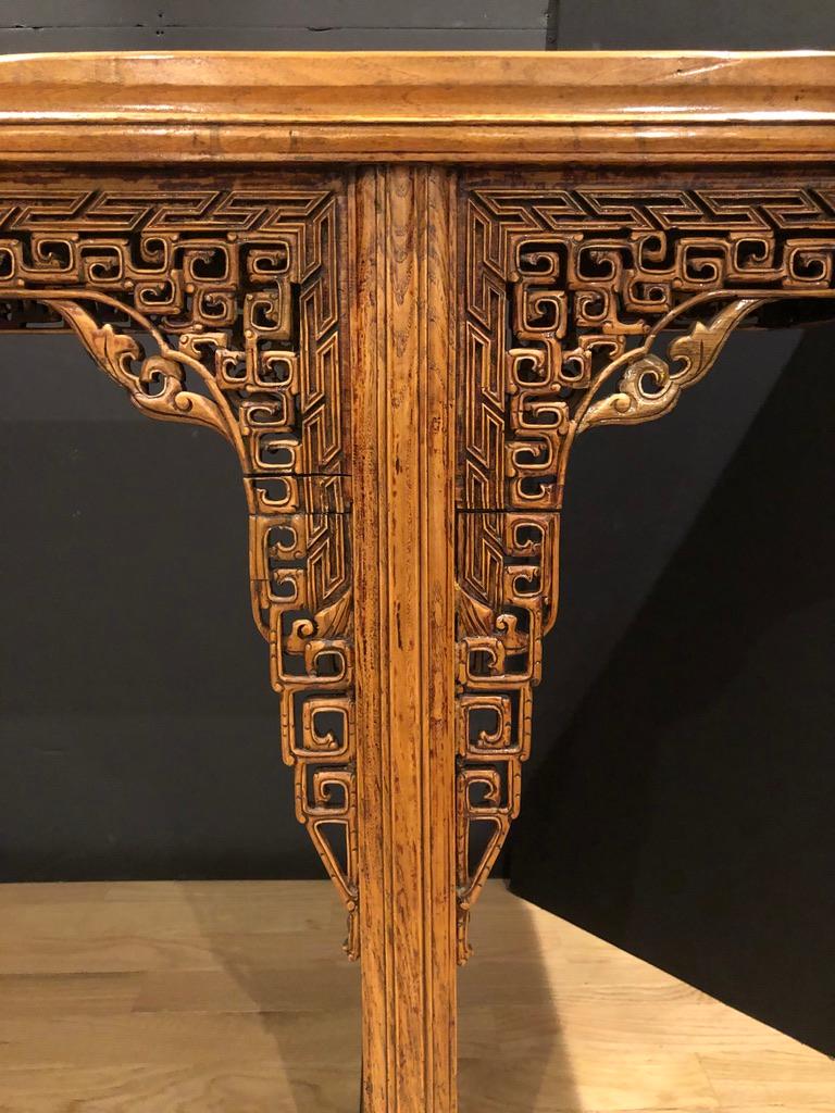 Impressive Chinese 19th century alter table. Console table with fine carving. Fretwork along the entirety of the front and back. This work continues down the pedestal legs. Pedestal legs with high relief foliate carving. The wood has been cleaned
