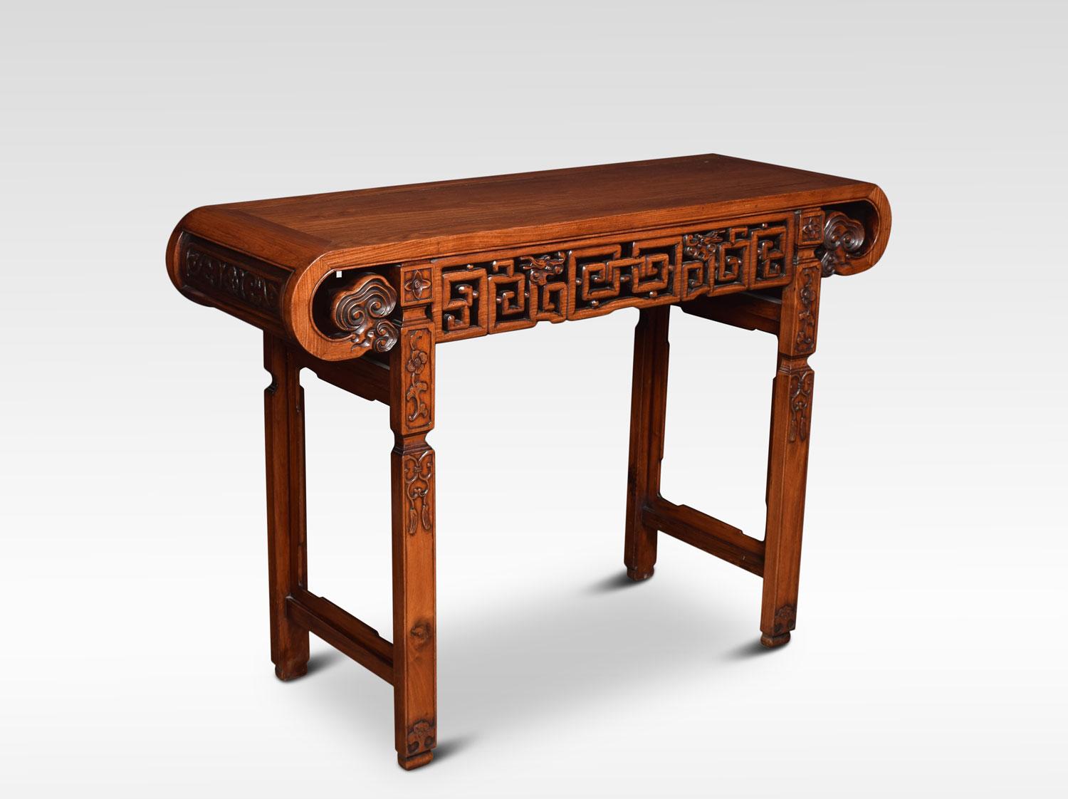 Chinese alter table the rectangular top with shaped ends. To the geometrically pierced frieze carved with dragons heads. All raised up on square section legs. With flowering stems and tassel and scrollwork, united by stretchers.
Dimensions:
Height