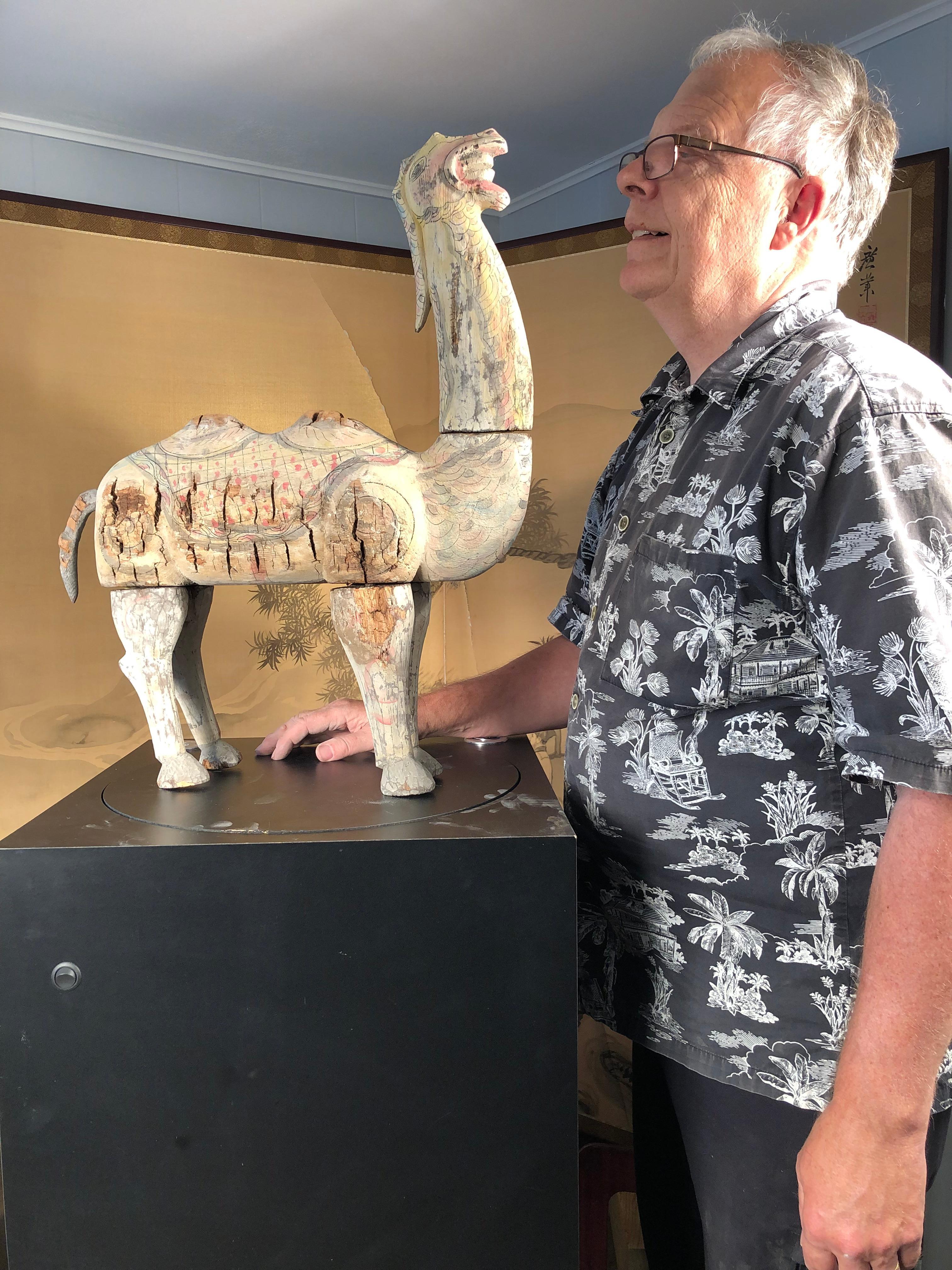 A Chinese hand carved and hand painted wooden effigy of a stately Bactrian camel dating to before Song dynasty 1279 AD.
Please enjoy the beautiful remnants of its aged original swirling painted surfaces. It has been traditionally carved and