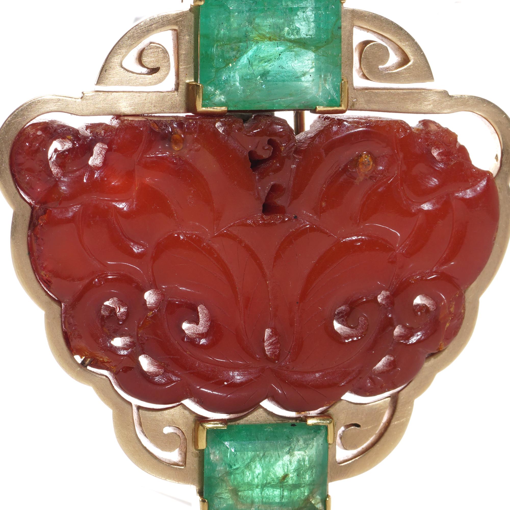 Antique Chinese 14kt. gold and carved amber clip pin brooch set with two Columbian emeralds. 
X-ray tested for 14kt gold. 
Made in Circa, 1920s. 

Dimensions:
The brooch height x width: 5.3 x 5.5 cm  
Total weight: 37.8 grams 

Emeralds  -
Quantity: