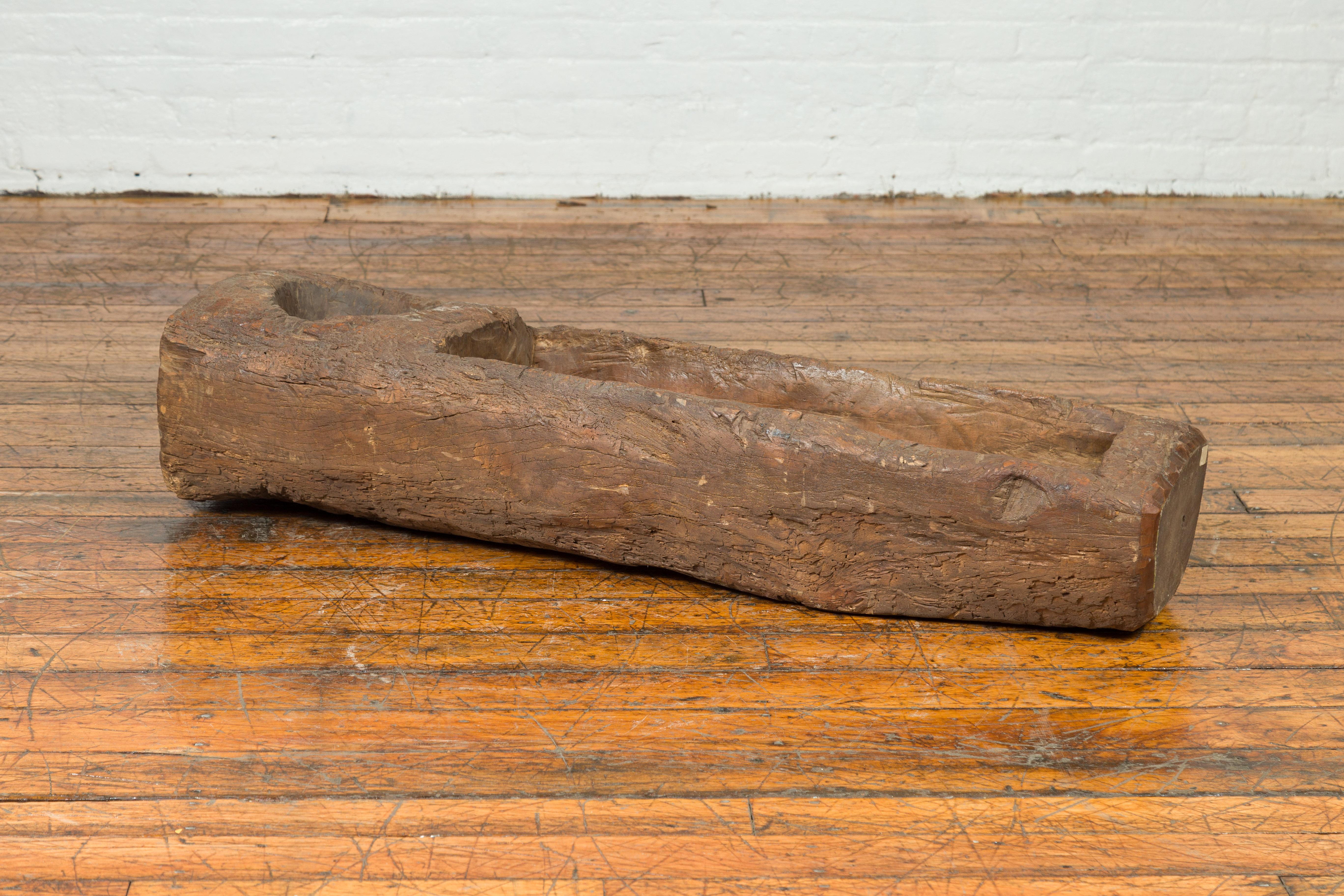 An antique 19th century or older Chinese wooden mortar planter of rustic appearance. Born in China where it was created to be used to store or grind up food, this wooden mortar charms our eyes with its simple appearance and nicely weathered patina.