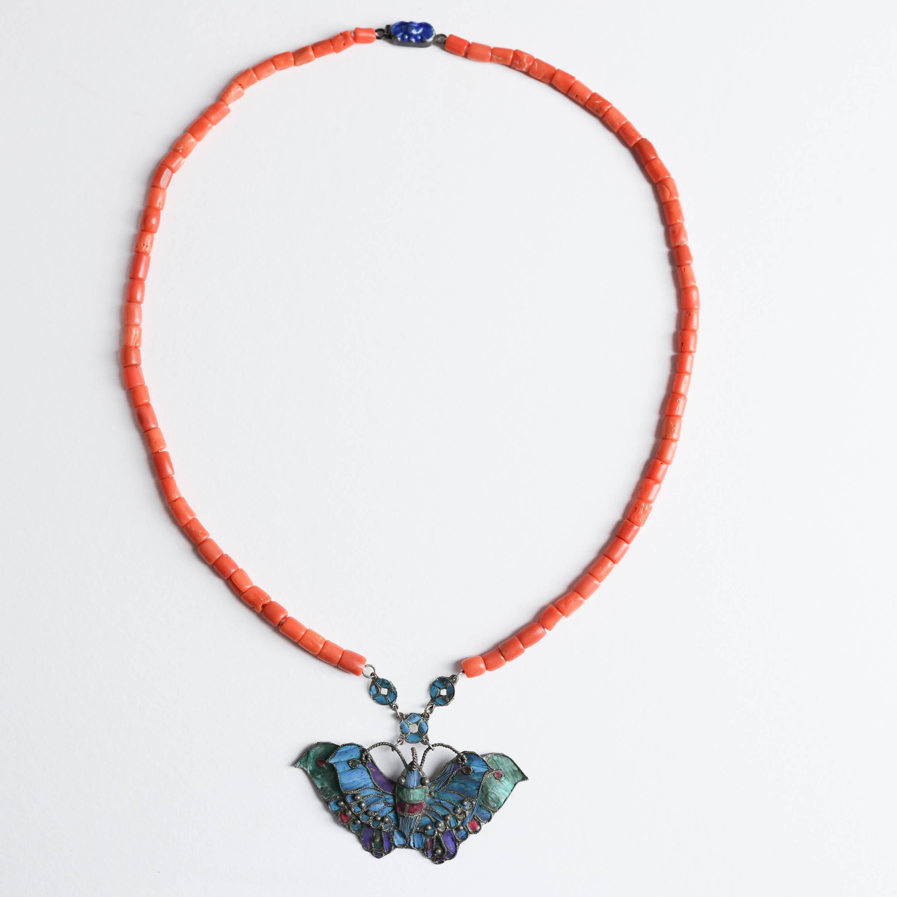 This strikingly unique Chinese Antique coral necklace from the Art Nouveau-era is an elegant and impressive example of the Chinese art form known as tian-tsui. 

Tian-tsui refers to the decoration of metalwork with the azure, iridescent feathers of