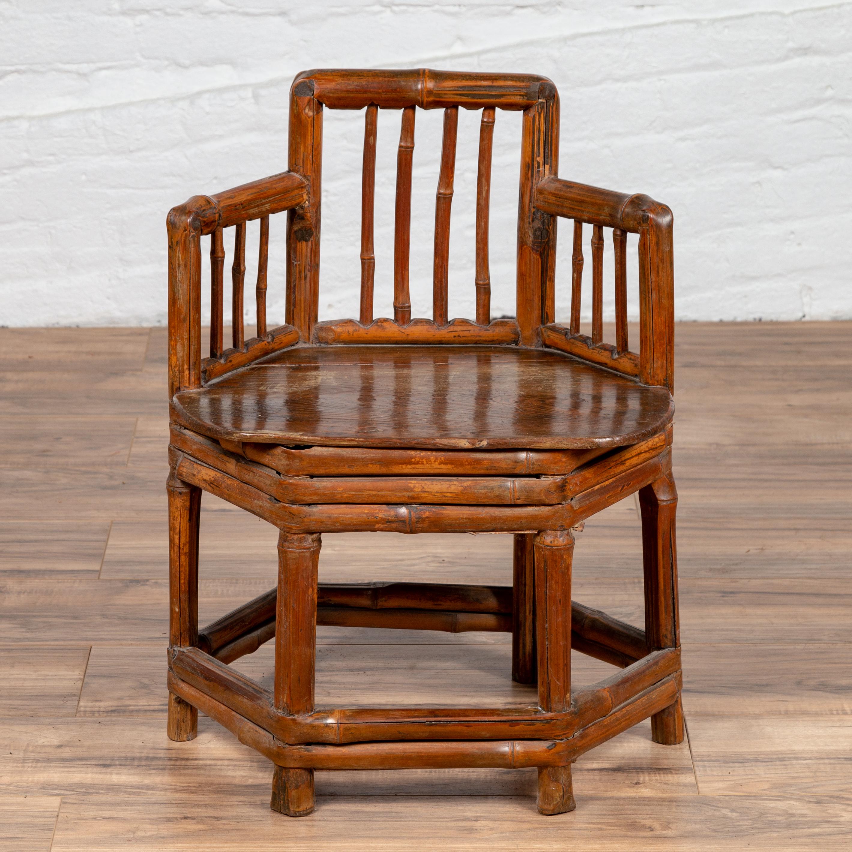 An antique Chinese child's corner chair from the 19th century, with bamboo frame and hexagonal base. Our hearts melt immediately upon inspection of this rustic child's corner chair! An hexagonal bamboo base made of straight legs connected to one