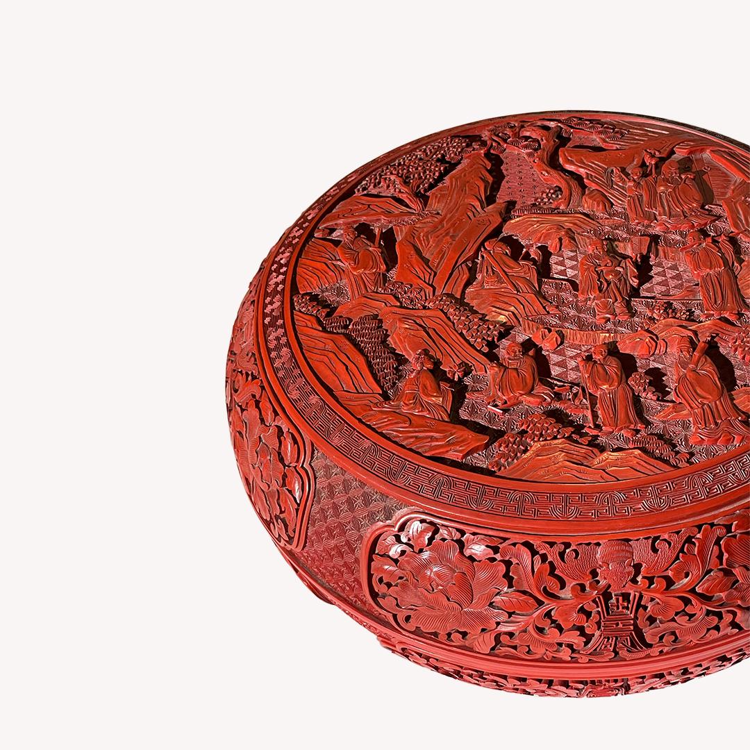 This extraordinary Chinese cinnabar lacquer round box is very detailed in amazing quality. 

A technique of engraving pattern on thick layer of red lacquer applied many times is used in this piece.

The lid has motifs of eight hermits and the