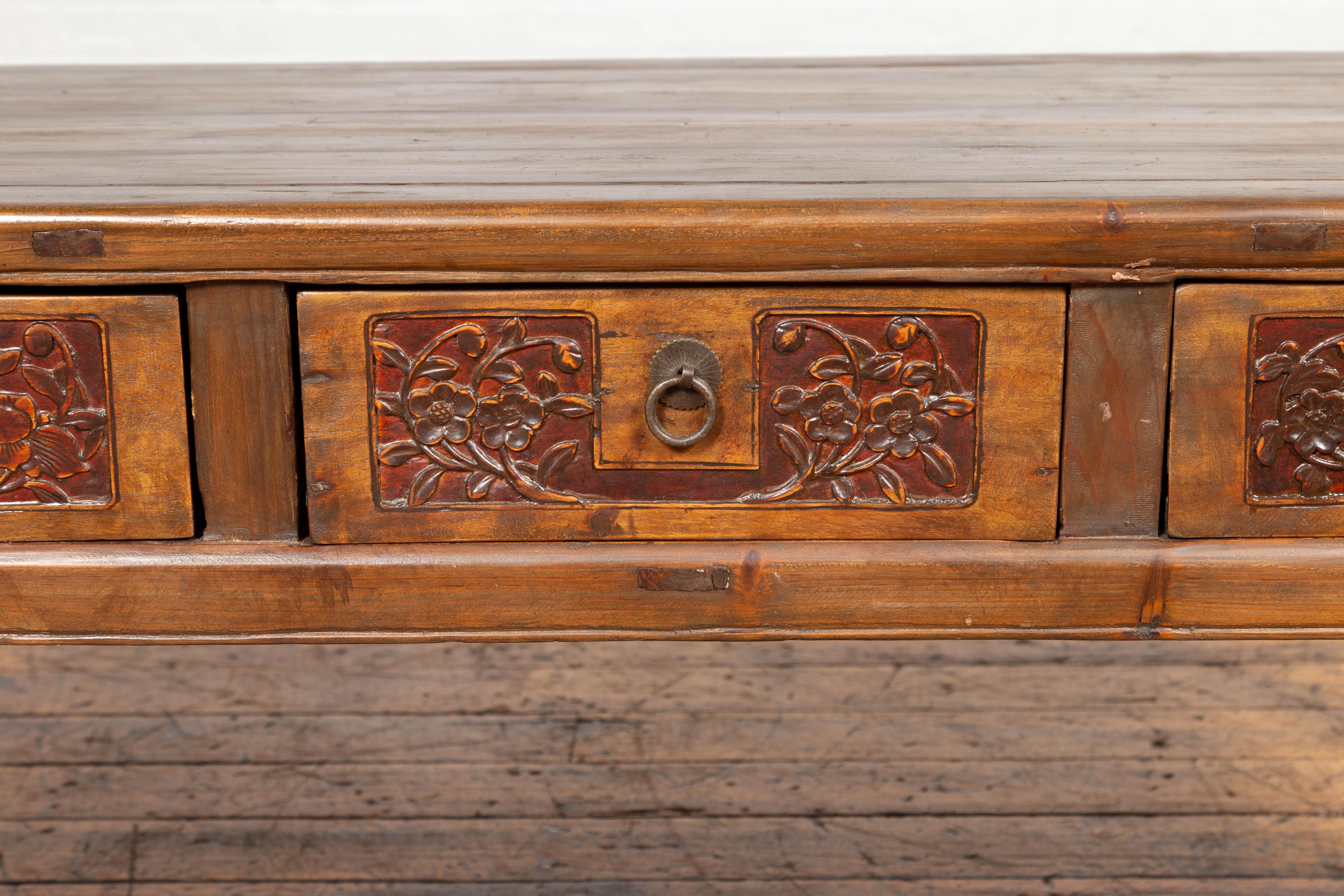 20th Century Chinese Antique Elm Coffee Table with Floral Carved Drawers and Horsehoof Legs