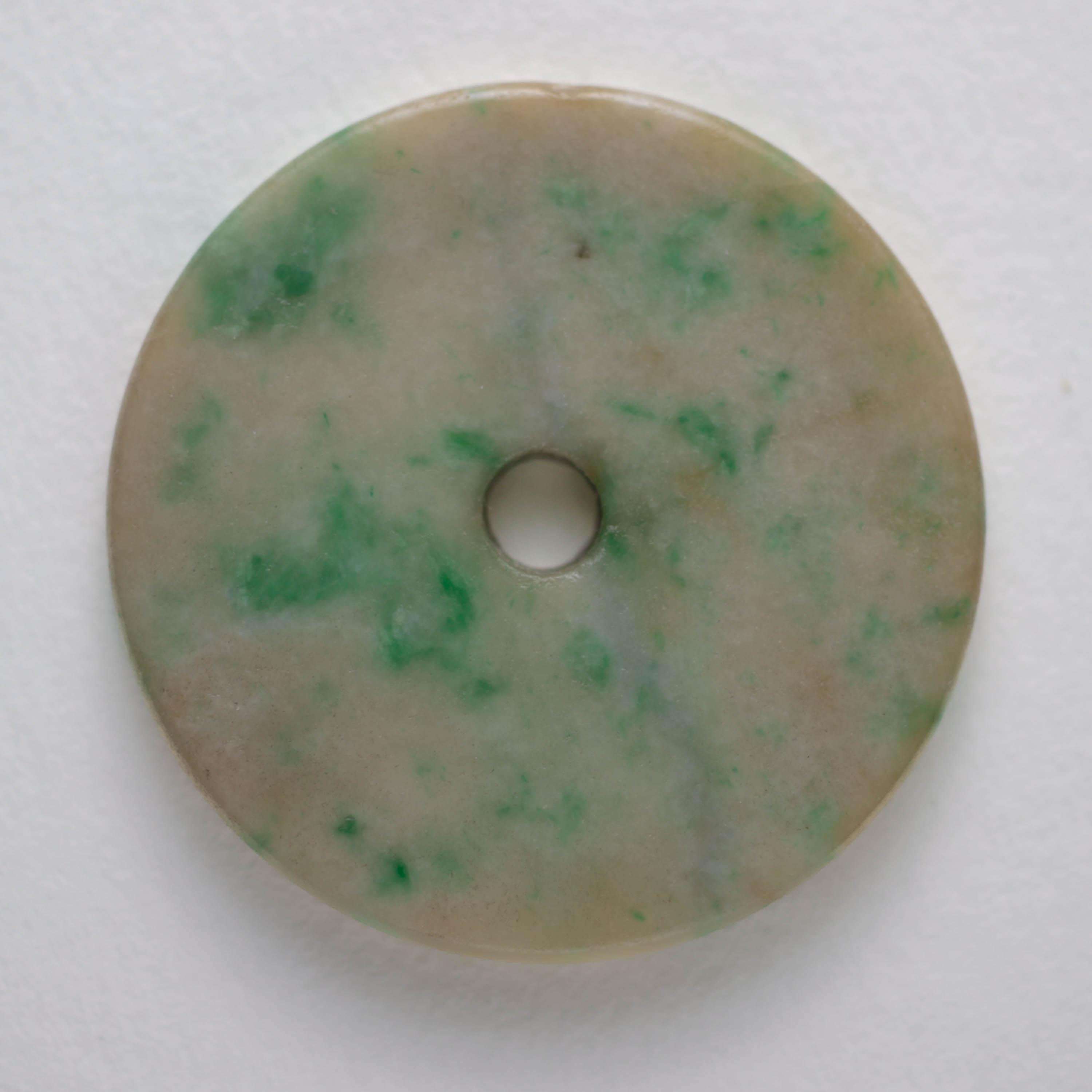 This exquisite Qing Dynasty period pi disk was carved by hand prior to 1900. The pi disk is simply carved, undecorated, and beautifully proportioned. The earliest Neolithic bi disks were simply carved and without ornamentation or decoration, exactly