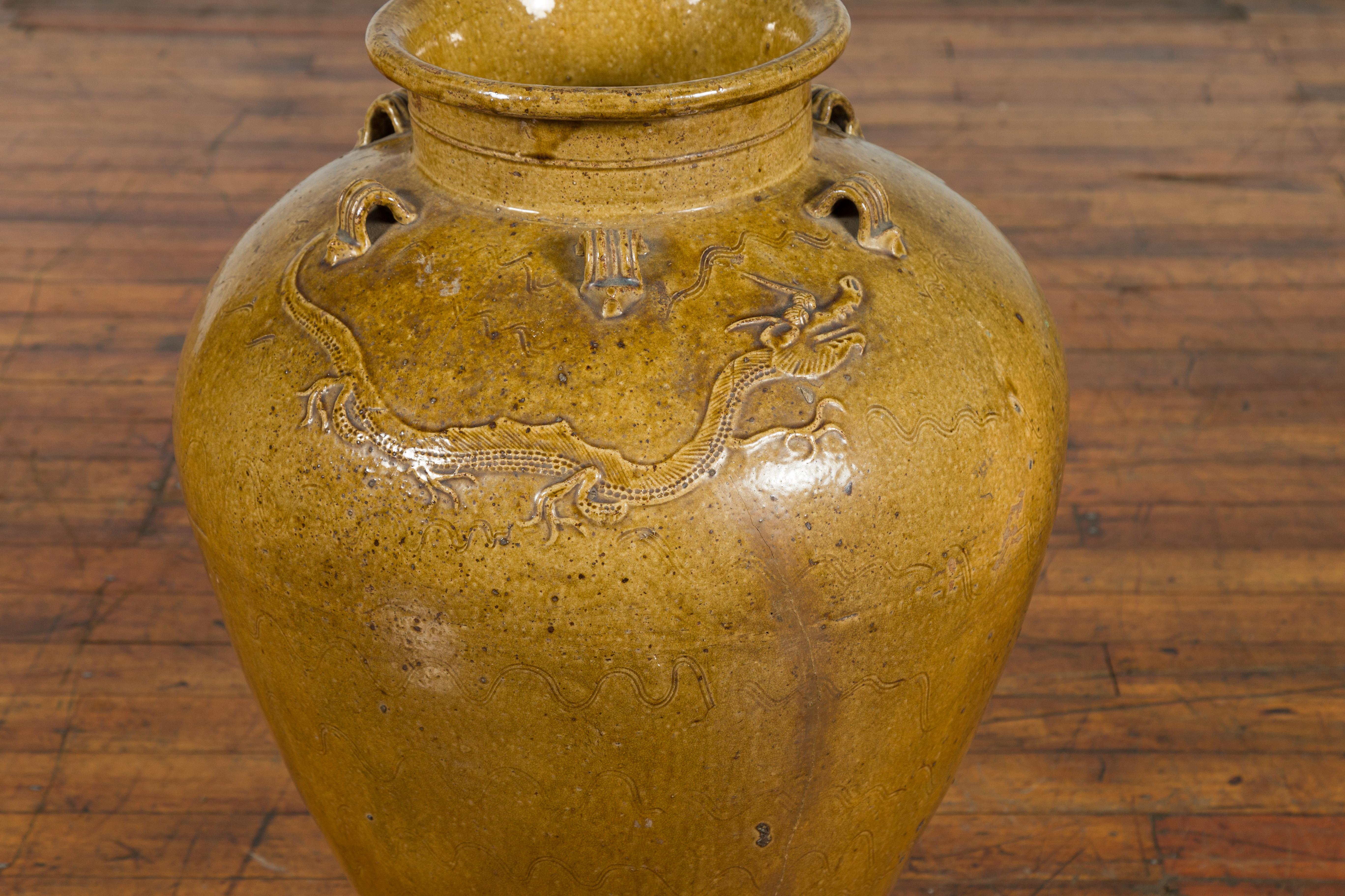 Glazed Chinese Antique Martaban Water Jar with Dragon Motifs and Ocher Glaze For Sale