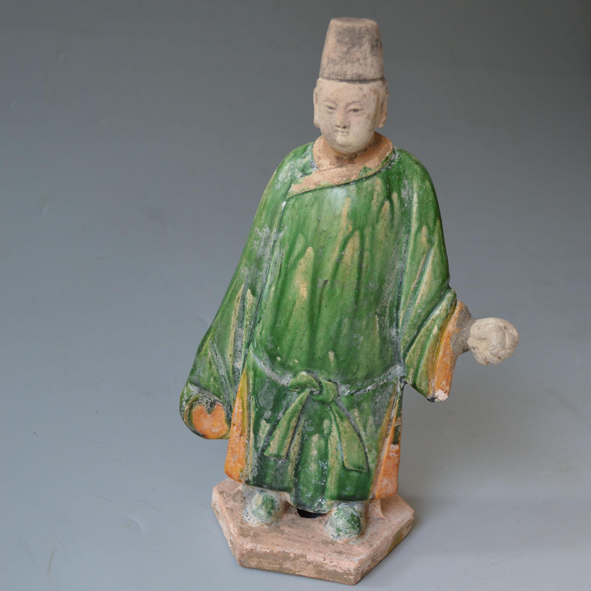 Chinese Antique Ming Dynasty glazed pottery figure  Ming Dynasty circa (14-16 century AD) China,

The earthenware with green and yellow glaze

Measures: height 28 cm, width 20 cm

Condition: head hand re-attached no restorations.
 