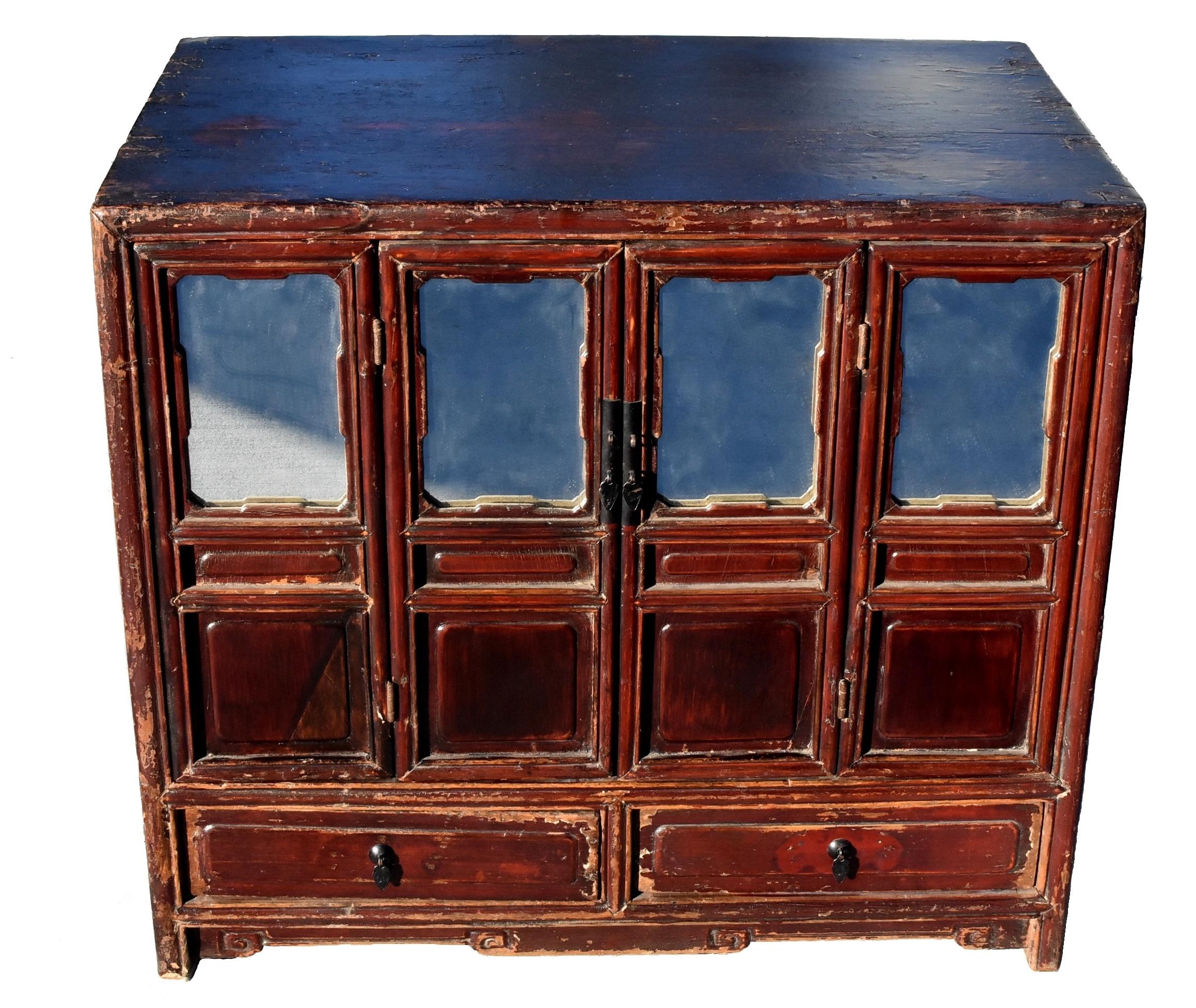 A beautiful, 19th century Kang chest in solid wood with mitered tenon and mortise construction. Four mirrored screen doors and 2 full depth drawers. Middle doors open to reveal a large storage interior space. Delicate style with solid stable