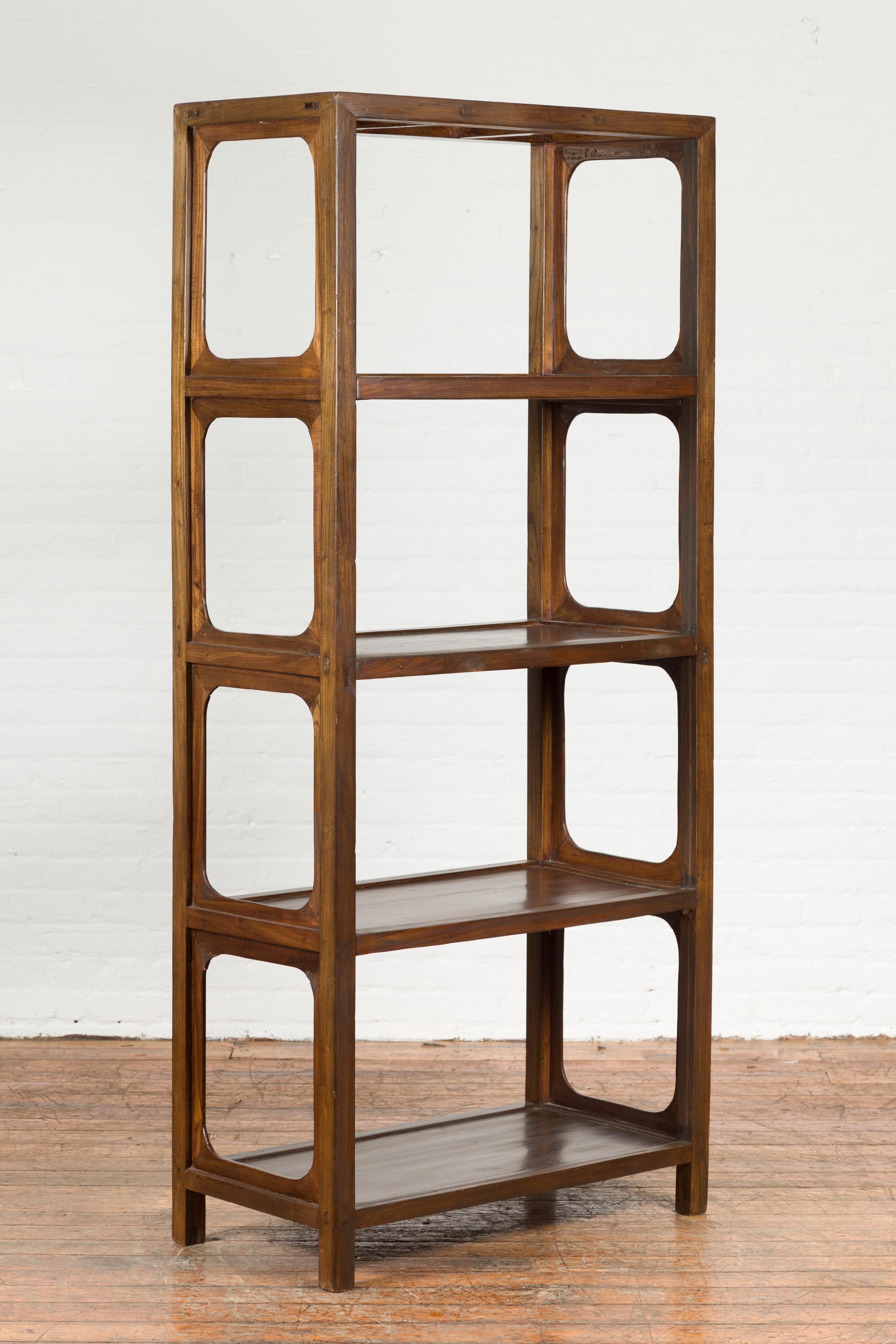 An antique Chinese original elmwood bookcase from the early 20th century, with open sides. Created in China, this elmwood bookcase features an open structure made of four shelves flanked with open sides. Raised on four short straight feet, this
