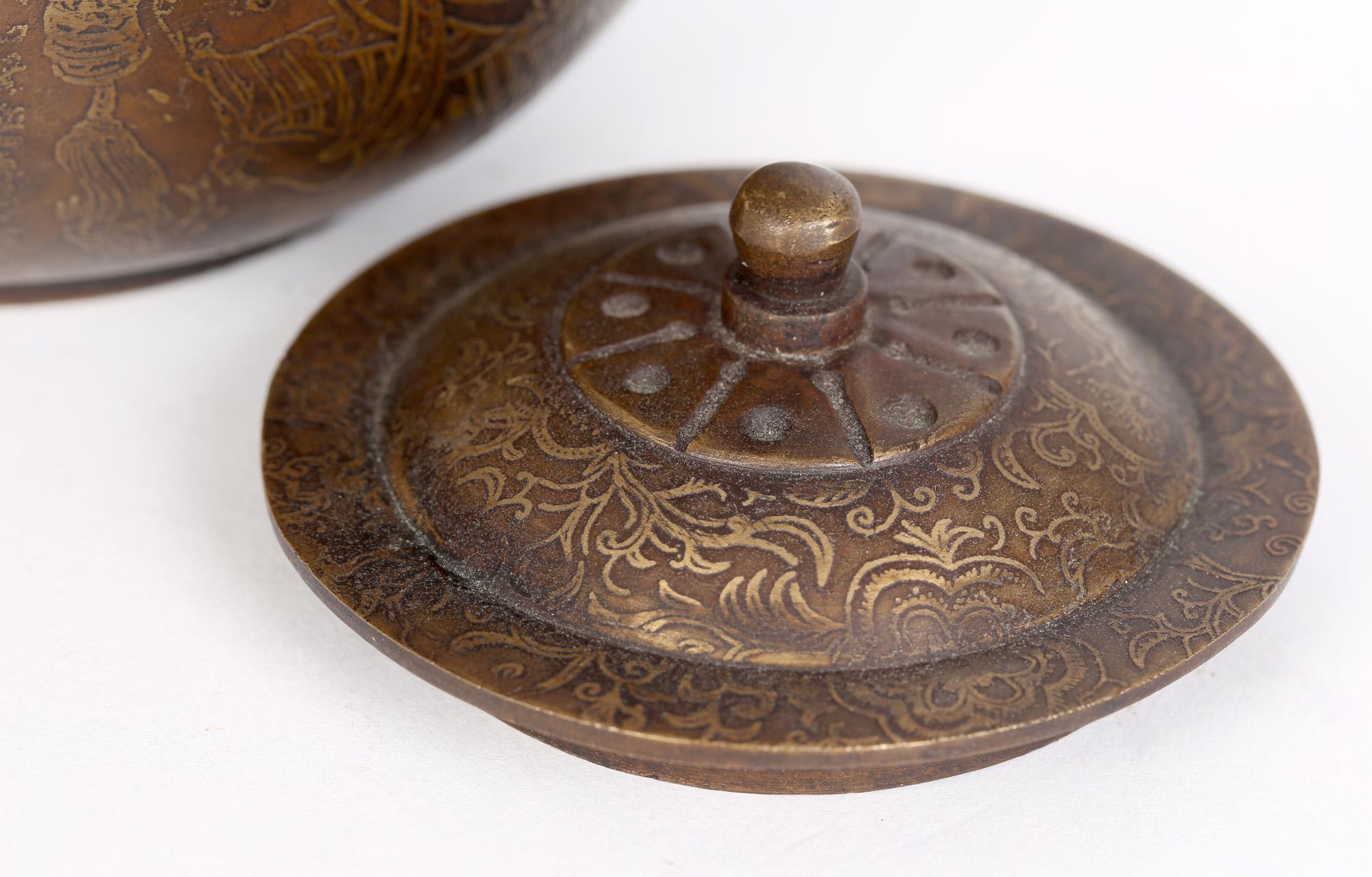 An interesting antique Chinese, Qianlong mark bronze teapot with gilded overlay probably dating from the latter 19th century. The teapot is of rounded shape standing on flat rounded base with a a slightly squared off shoulder with raised roundel