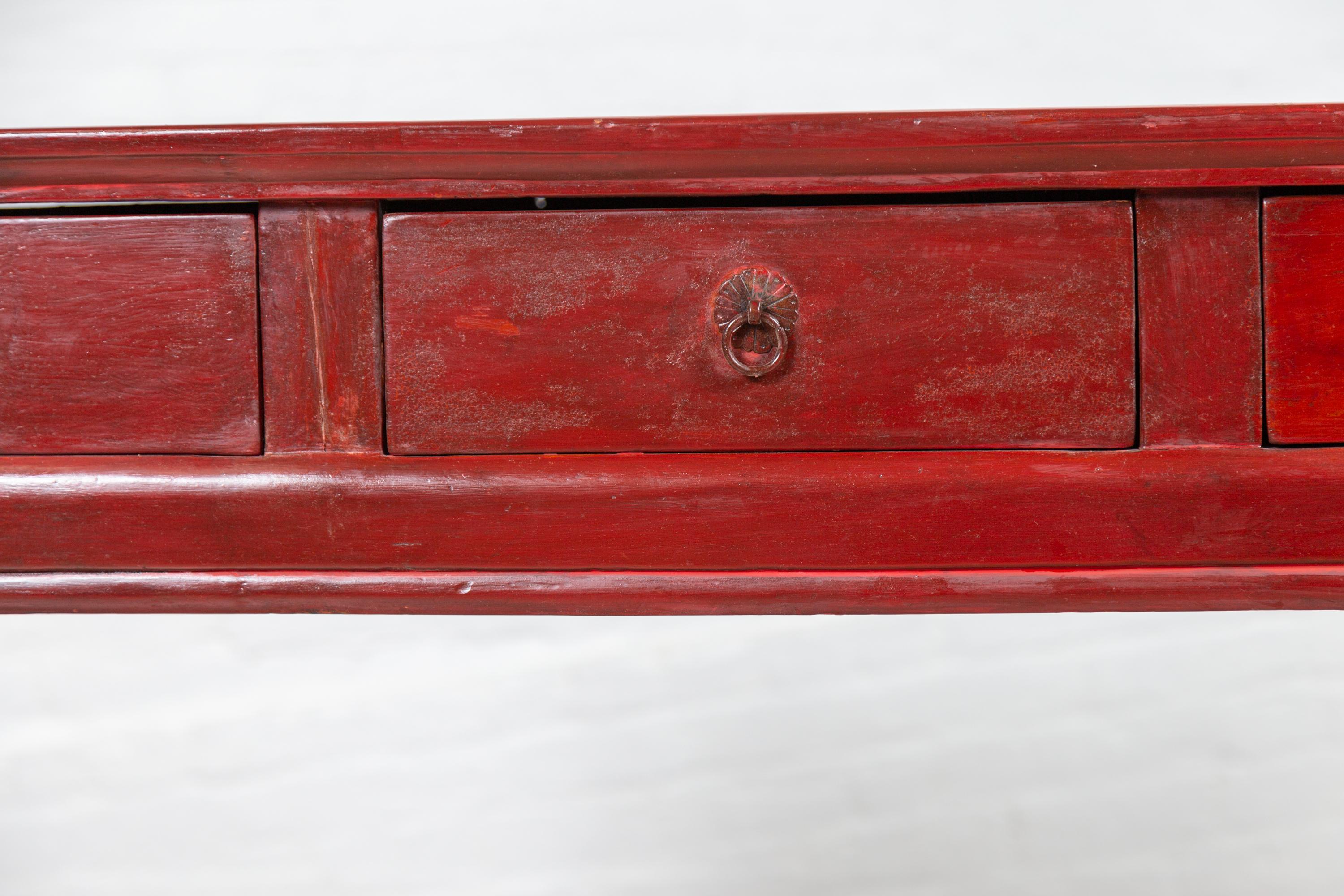 Chinese Antique Red Lacquered Wooden Desk with Four Drawers and Curling Scrolls In Good Condition In Yonkers, NY