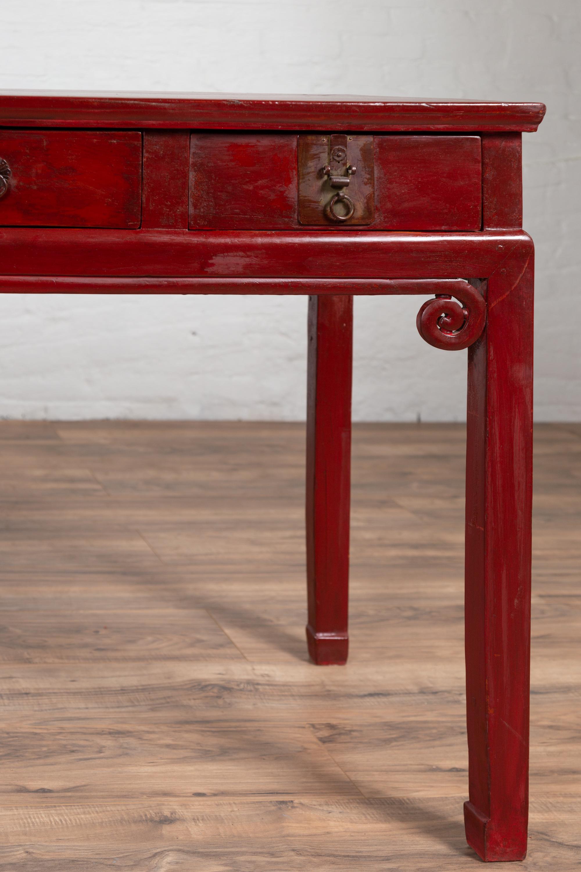 20th Century Chinese Antique Red Lacquered Wooden Desk with Four Drawers and Curling Scrolls