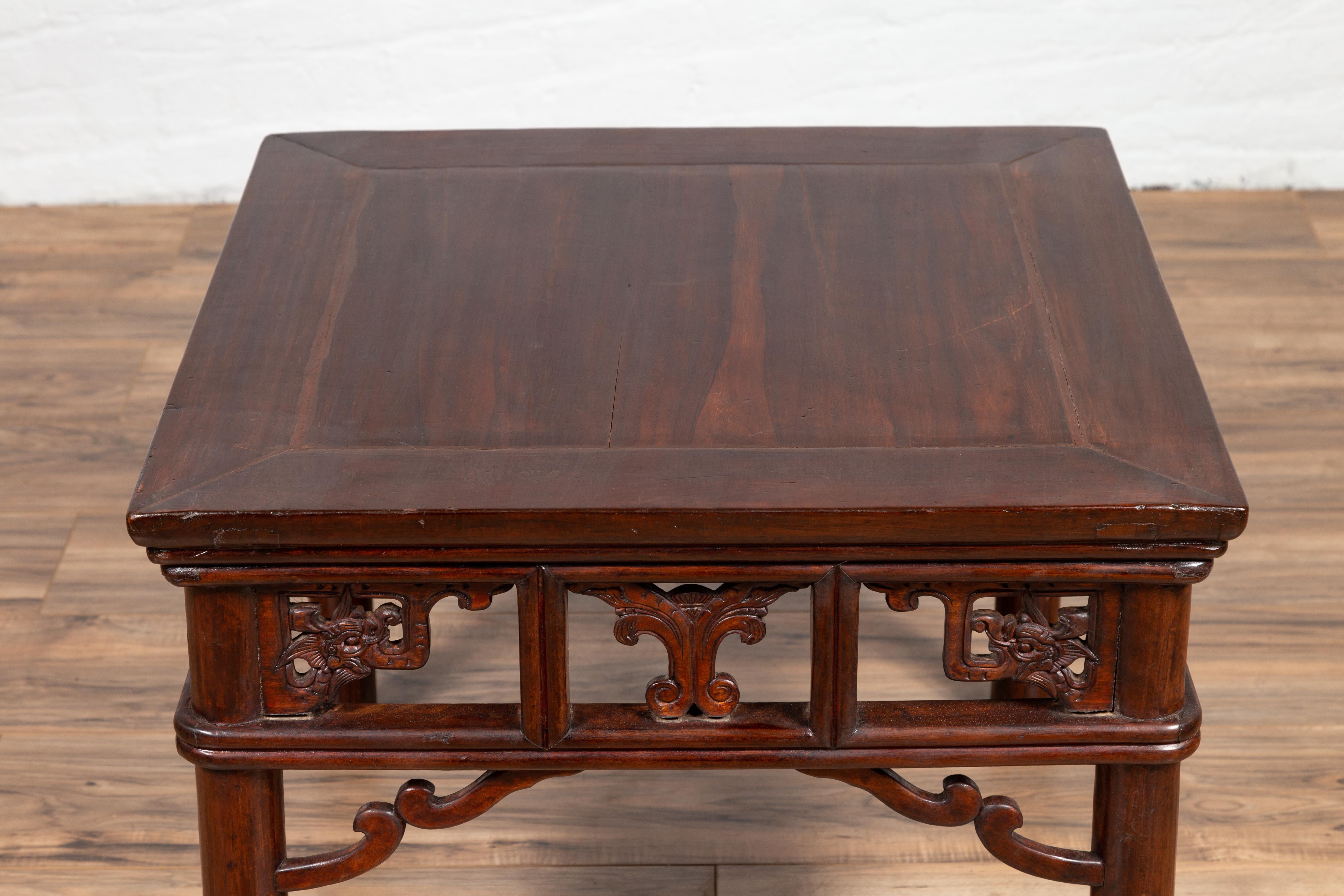 Hand-Carved Chinese Antique Side Table with Open Fretwork Design and Dark Wood Patina For Sale