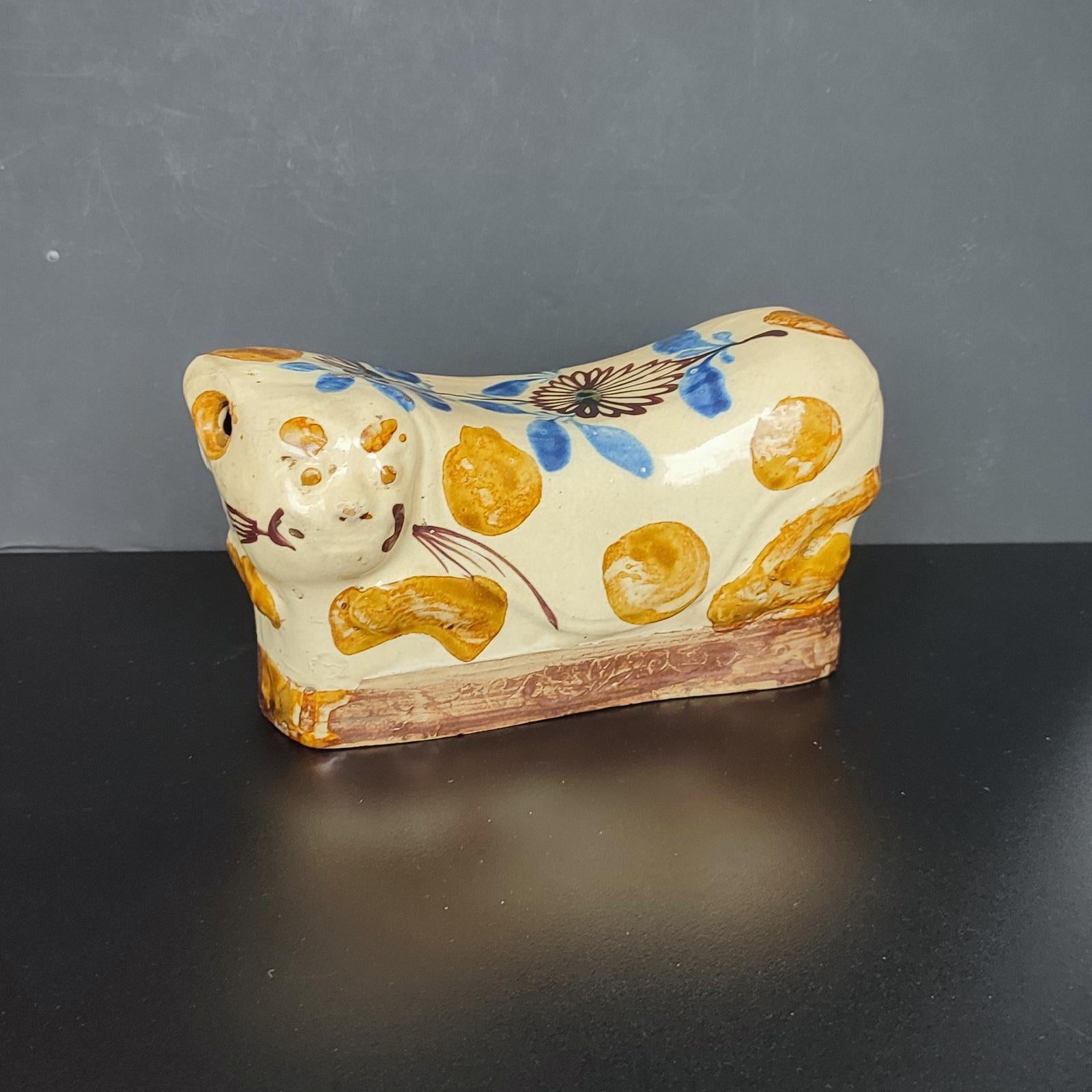 China, antique ceramic cat pillow, beautifully glazed in brown, cream, and cobalt blue, with good, even wear from genuine use. It is a fine collectible from the late Qing dynasty. 