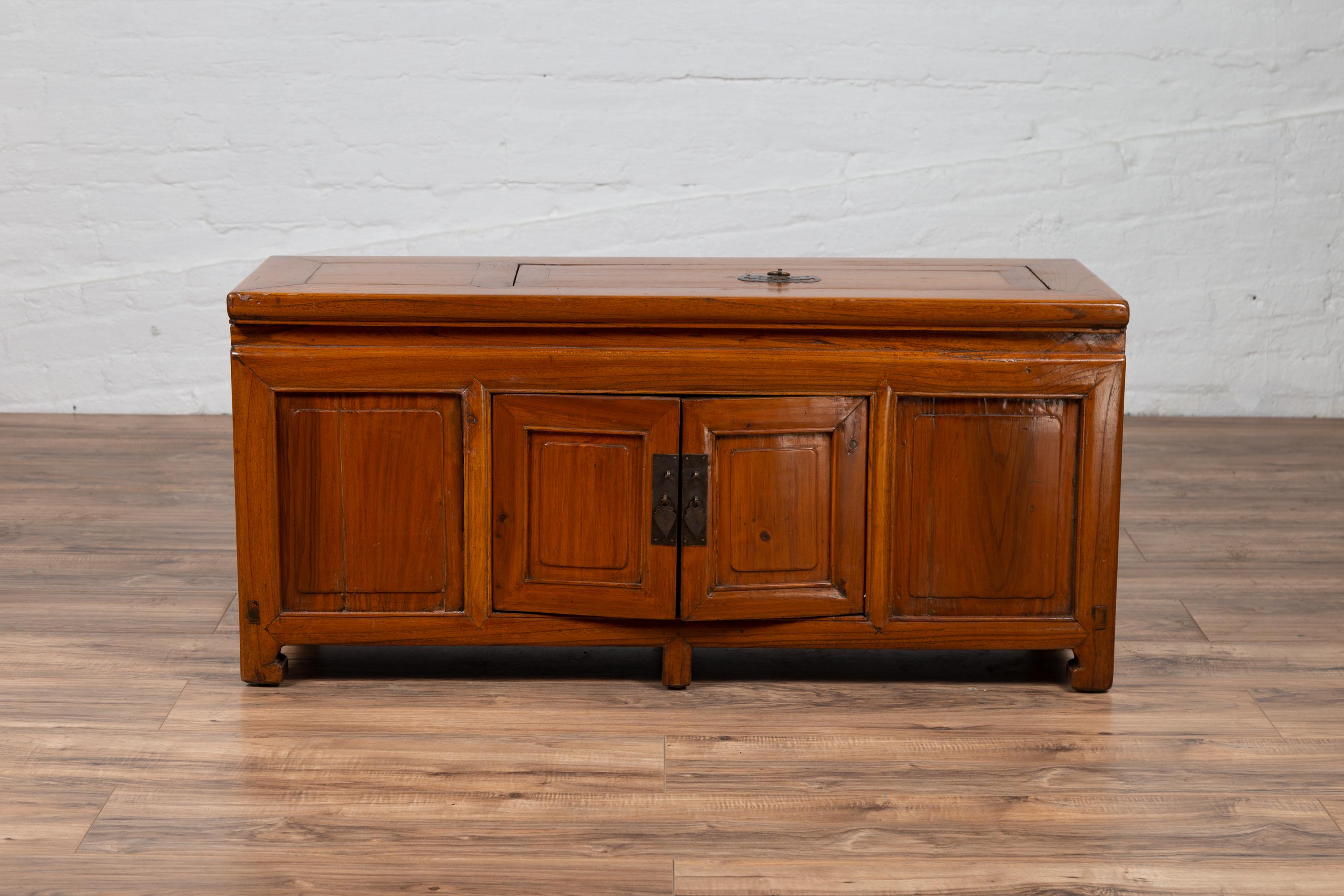 A Chinese antique two-door buffet from the early 20th century, with upper removable board. Born in China during the early years of the 20th century, this charming buffet features a rectangular planked top, presenting an unusual removable board