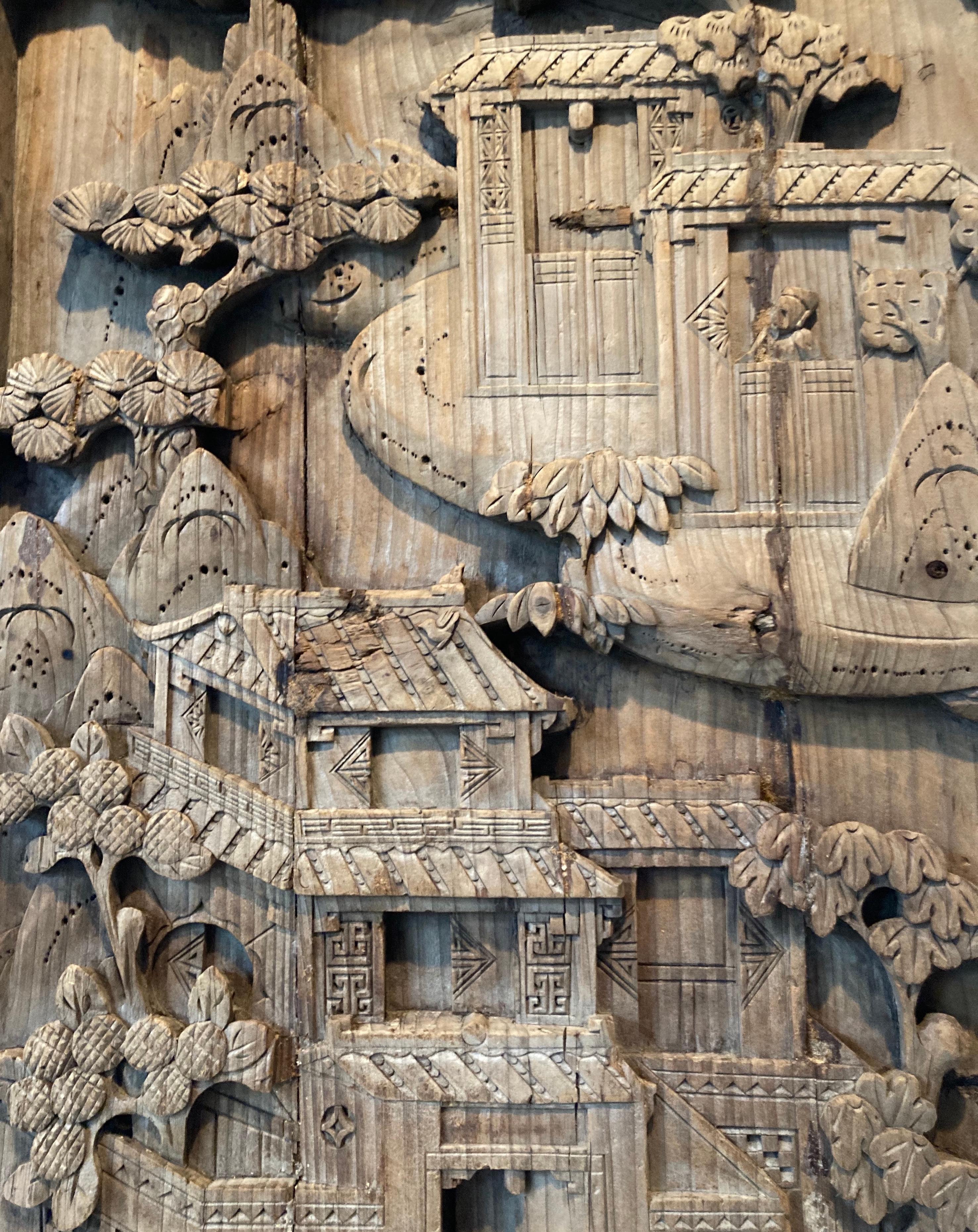 Unframed panel with relief carving. Joined plank carving with dwelling in the clouds motif.