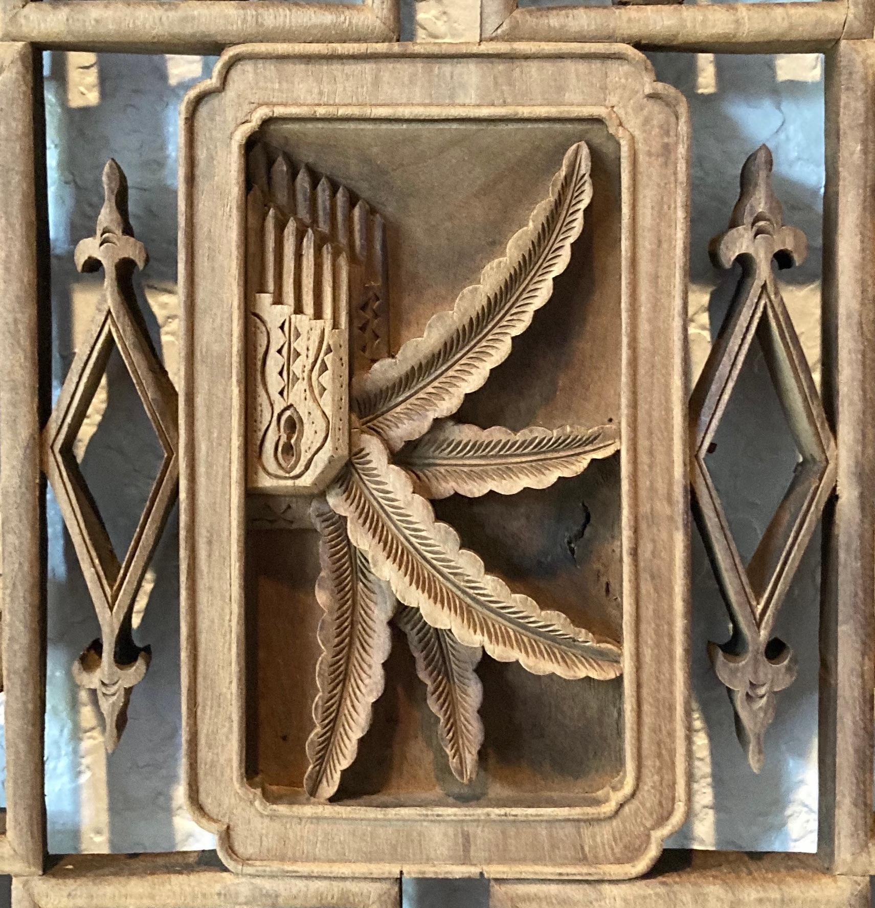 Unframed panel with openwork carving. Carved from solid piece of wood. Rectangular center carving with palm leaf and floral motif.