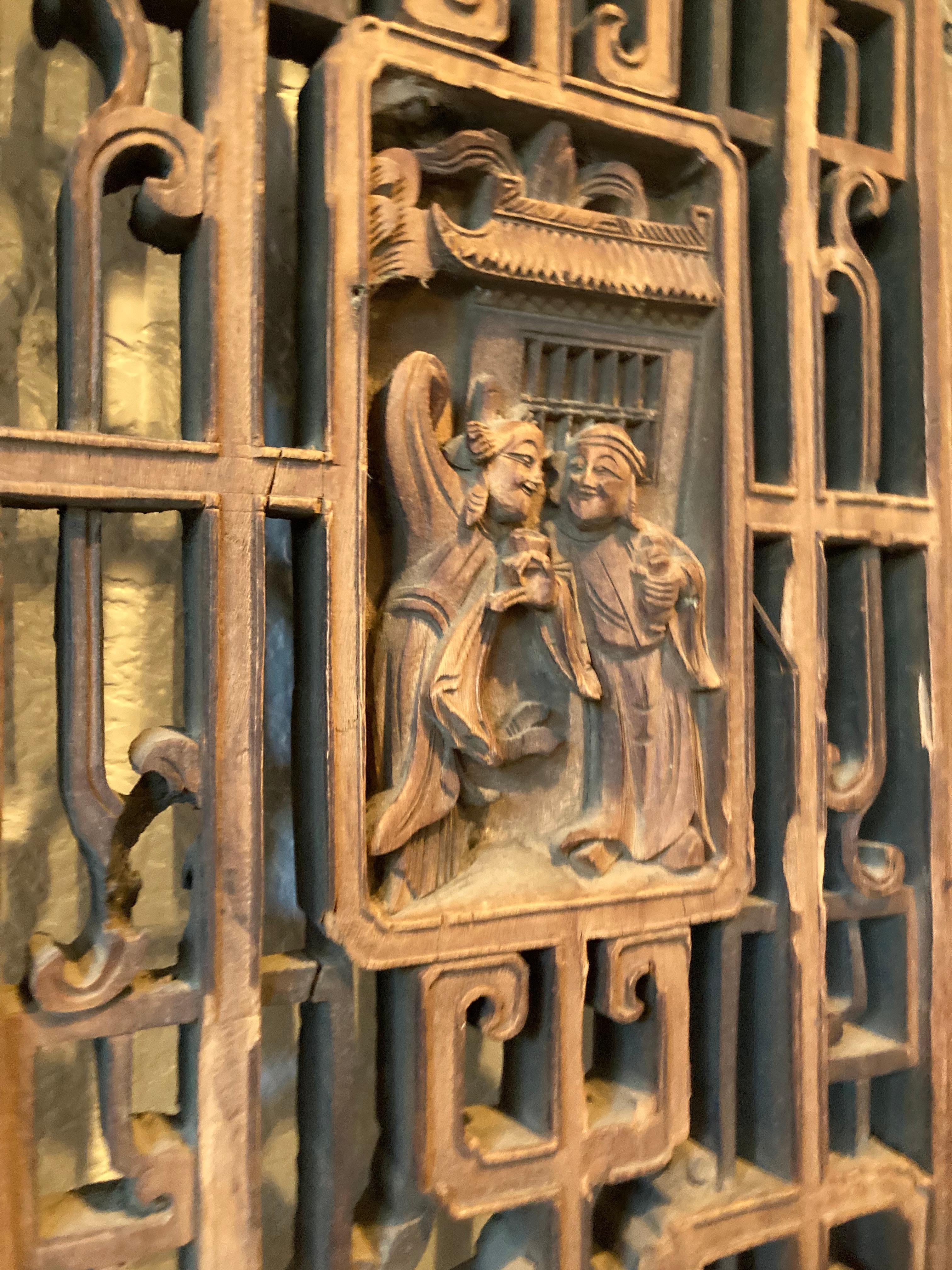 Framed panel with mitered mortise and tenon joints. Panes include openwork and relief carvings, with personage motifs.