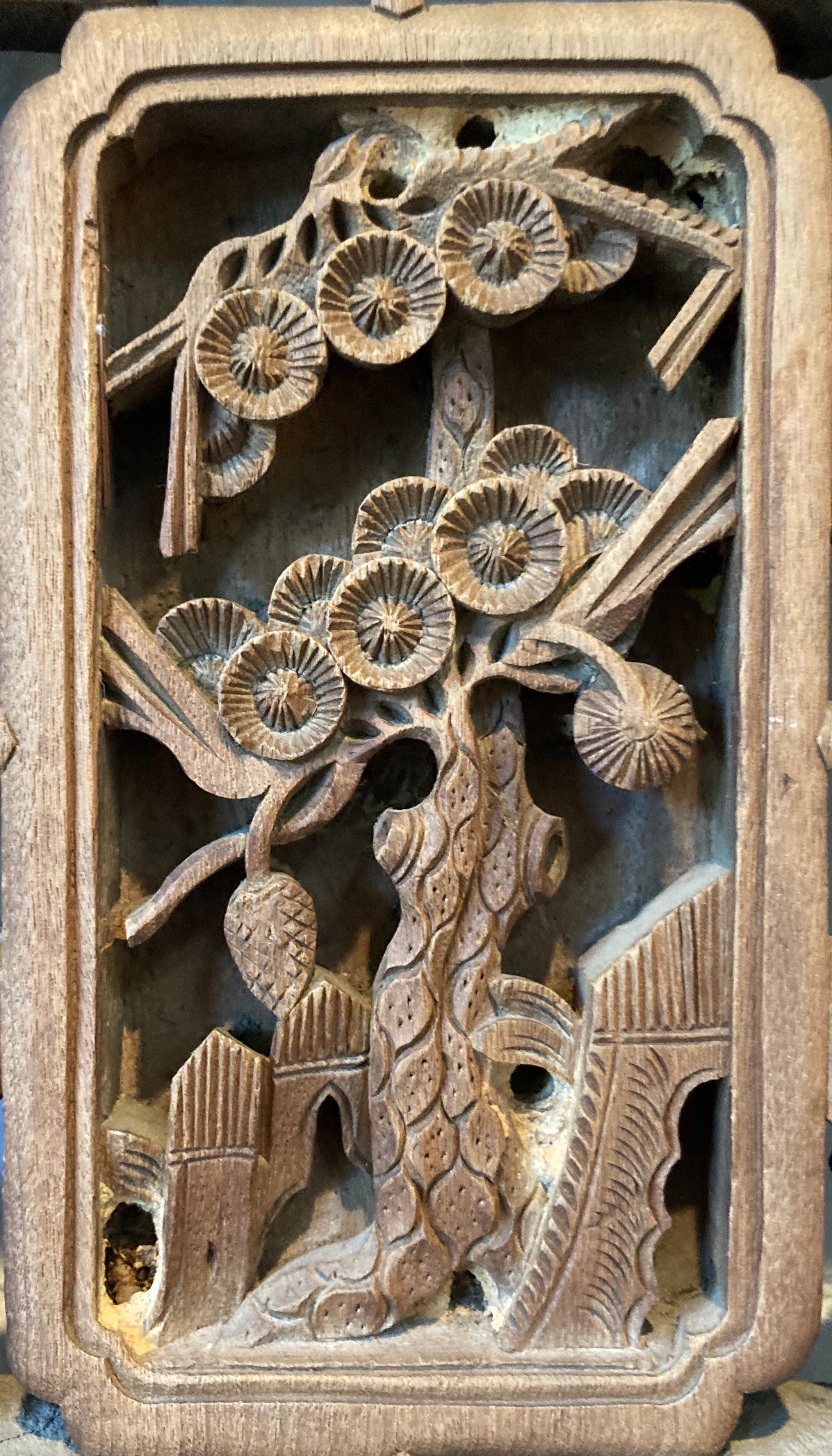 Framed panel with mitered mortise and tenon joints. Panel includes three panes, with openwork and relief carvings. Panes include rectangular center carving with floral motif.