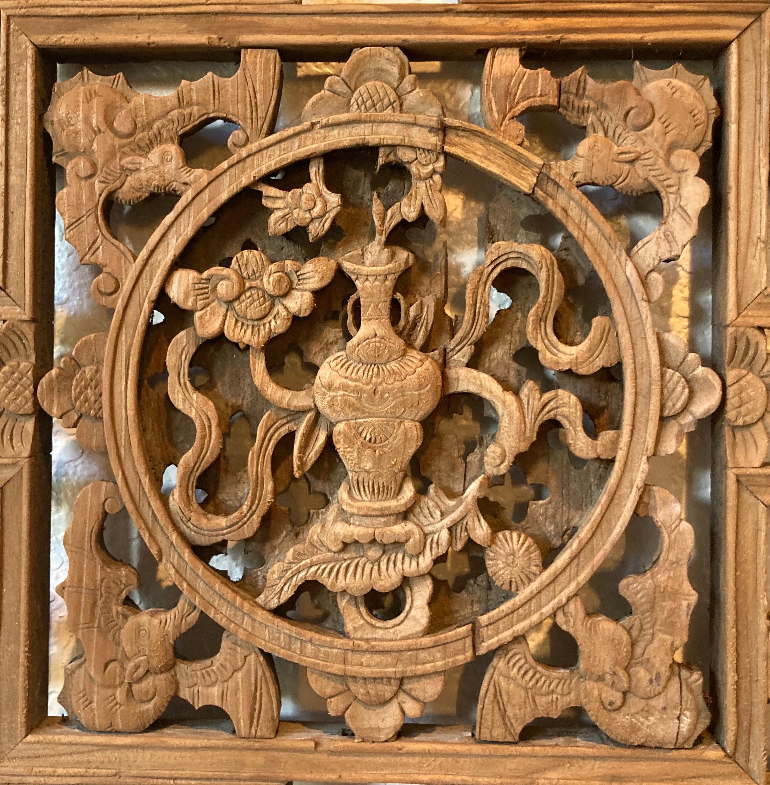 Lattice panels with mitered mortise and tenon joints. Panels include square center carving with vase/floral and bat motifs, and multiple small carved objects with floral motif.