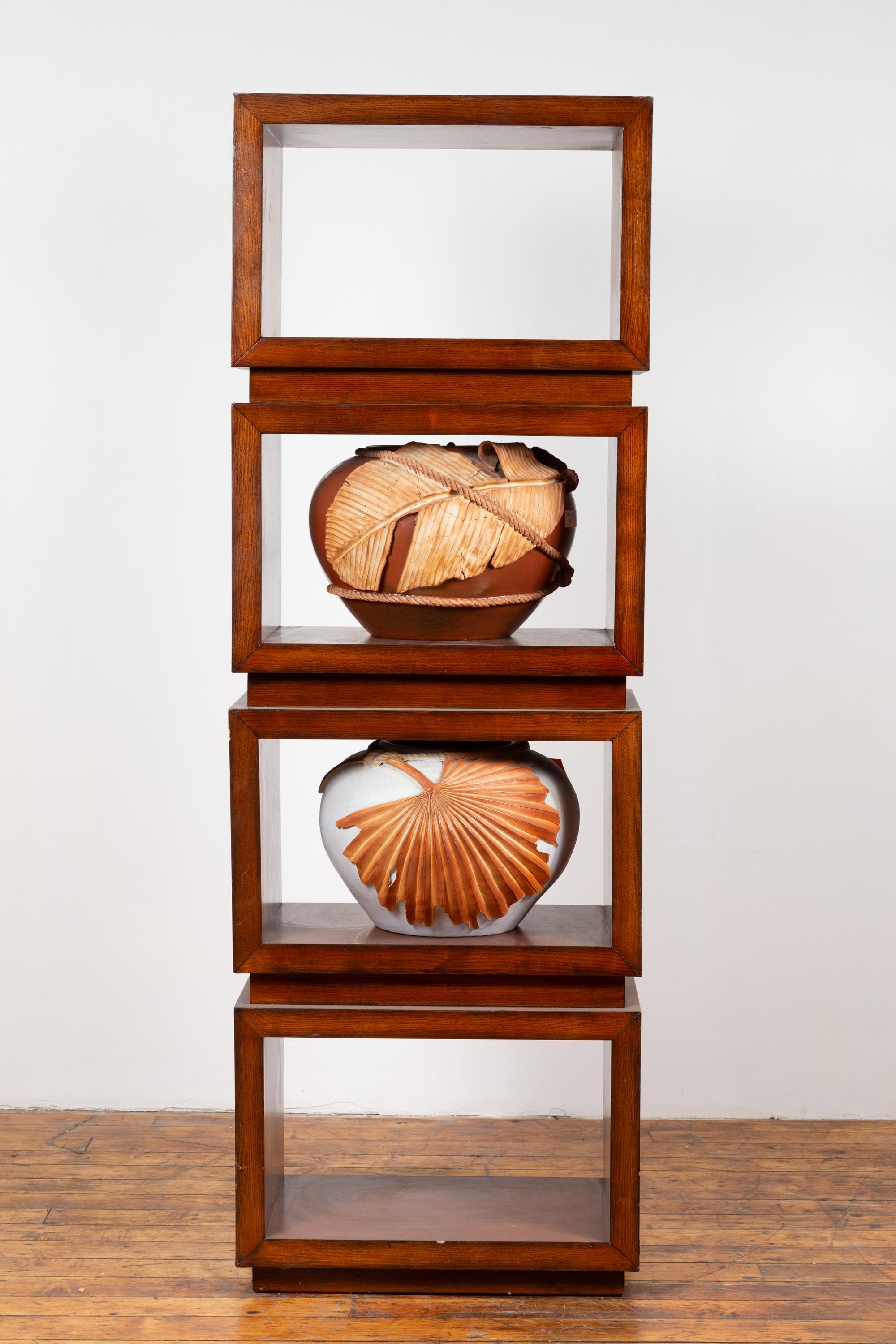 A contemporary Chinese bookcase from the late 20th century, with four open rectangular shelves. Born in China during the late years of the 20th century, this Chinese étagère features an unusual Silhouette, presenting four open shelves of rectangular