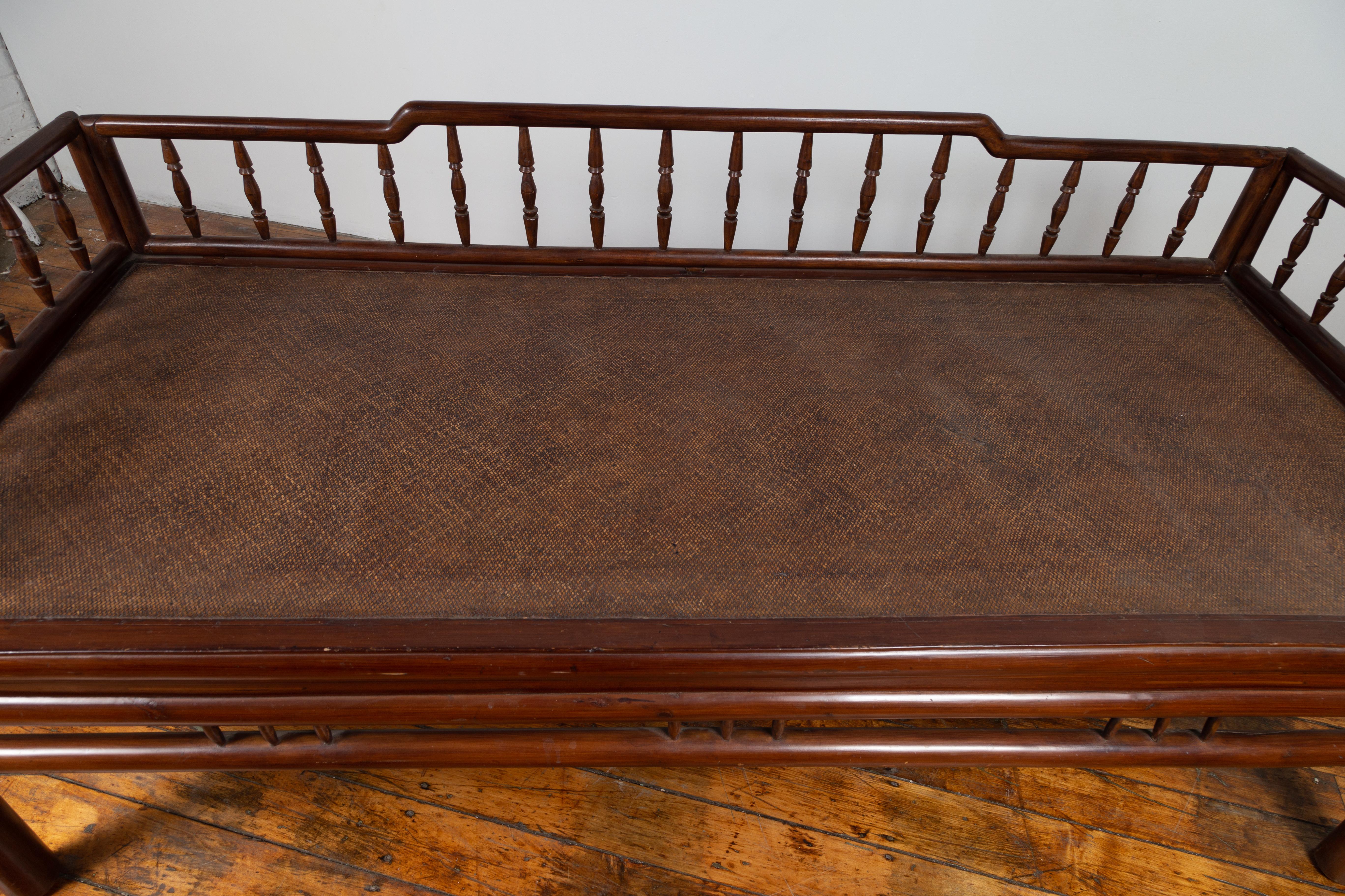 20th Century Chinese Antique Wooden Daybed with Woven Rattan Seat and Spindle Accents