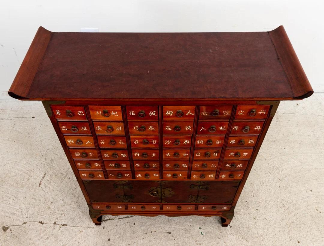Chinese Apothecary cabinet with 40 drawers and sliding door below. Metal drawer pulls. Some wear from age and use. Please note of wear consistent with age.