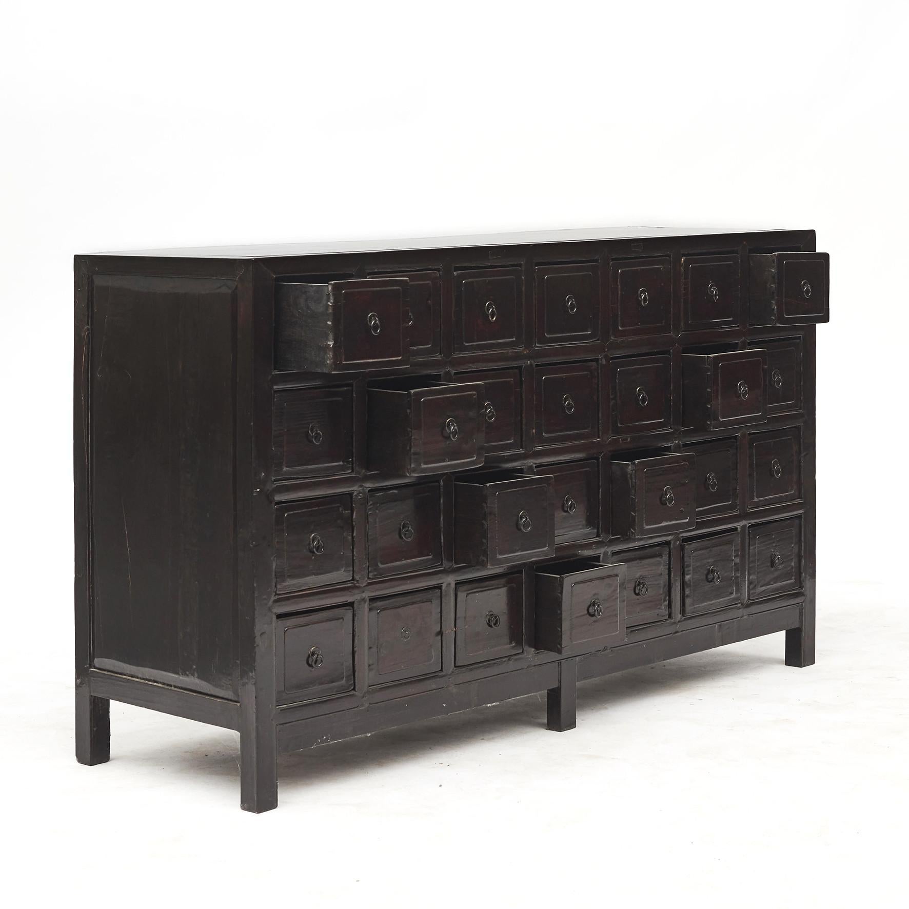 Chinese apothecary / pharmacy medicine chest with 28 drawers in black / burgundy lacquer. From Jiangsu Province, late 19th century.