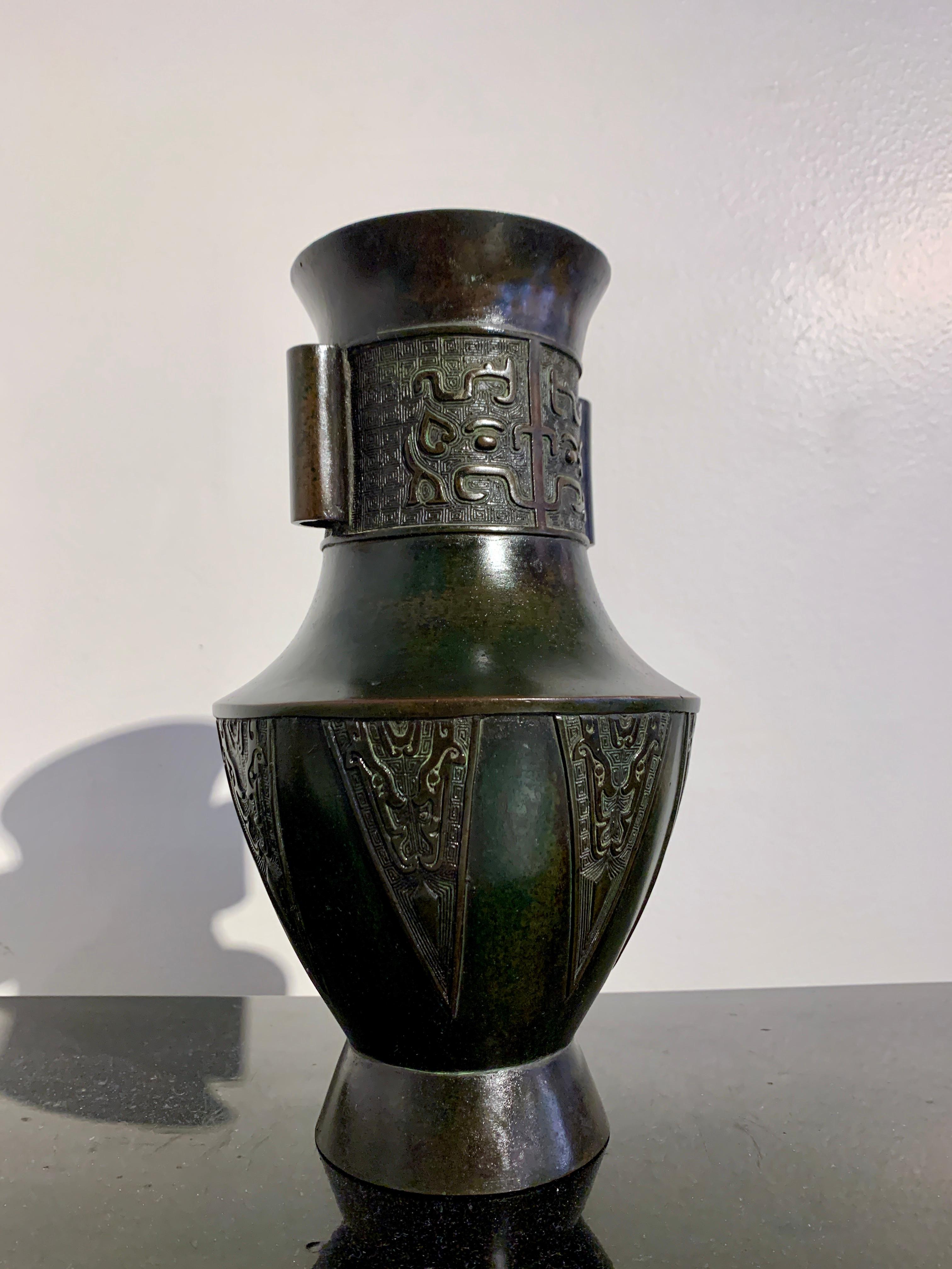 An attractive and well cast Chinese archaistic bronze altar vase, hu, Republic Period (1911 to 1949), early 20th century, circa 1920, China.

The vase of elegant proportions, with a tapered body resting on a high, splayed foot. The low, angular