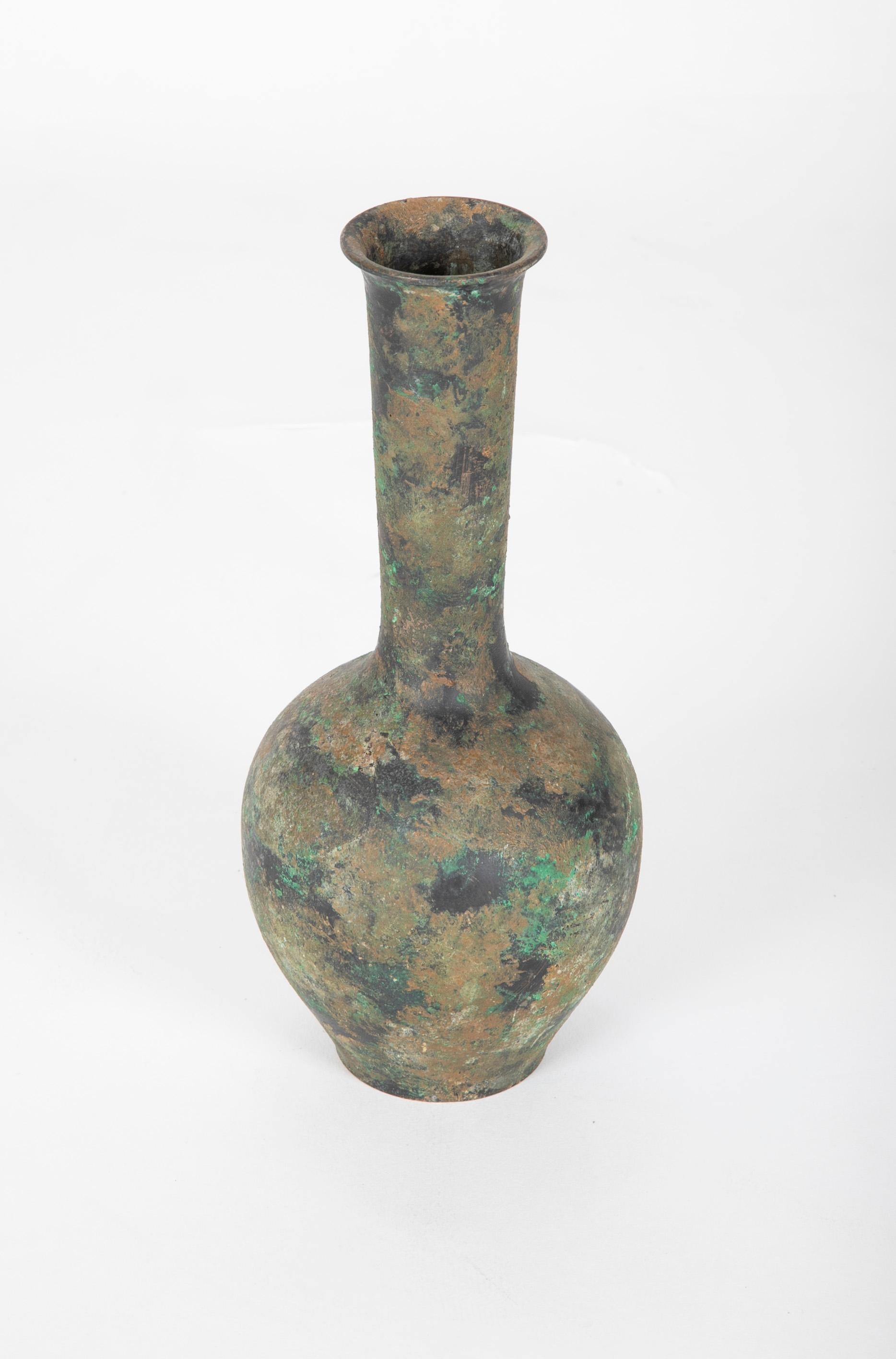 A handsome bronze bottle-form vase in the Chinese Archaistic style. The flaring neck above a bulbous body supported by a circular footed base. Encrusted surface nice showing a variegated patina, late 19th-early 20th century.