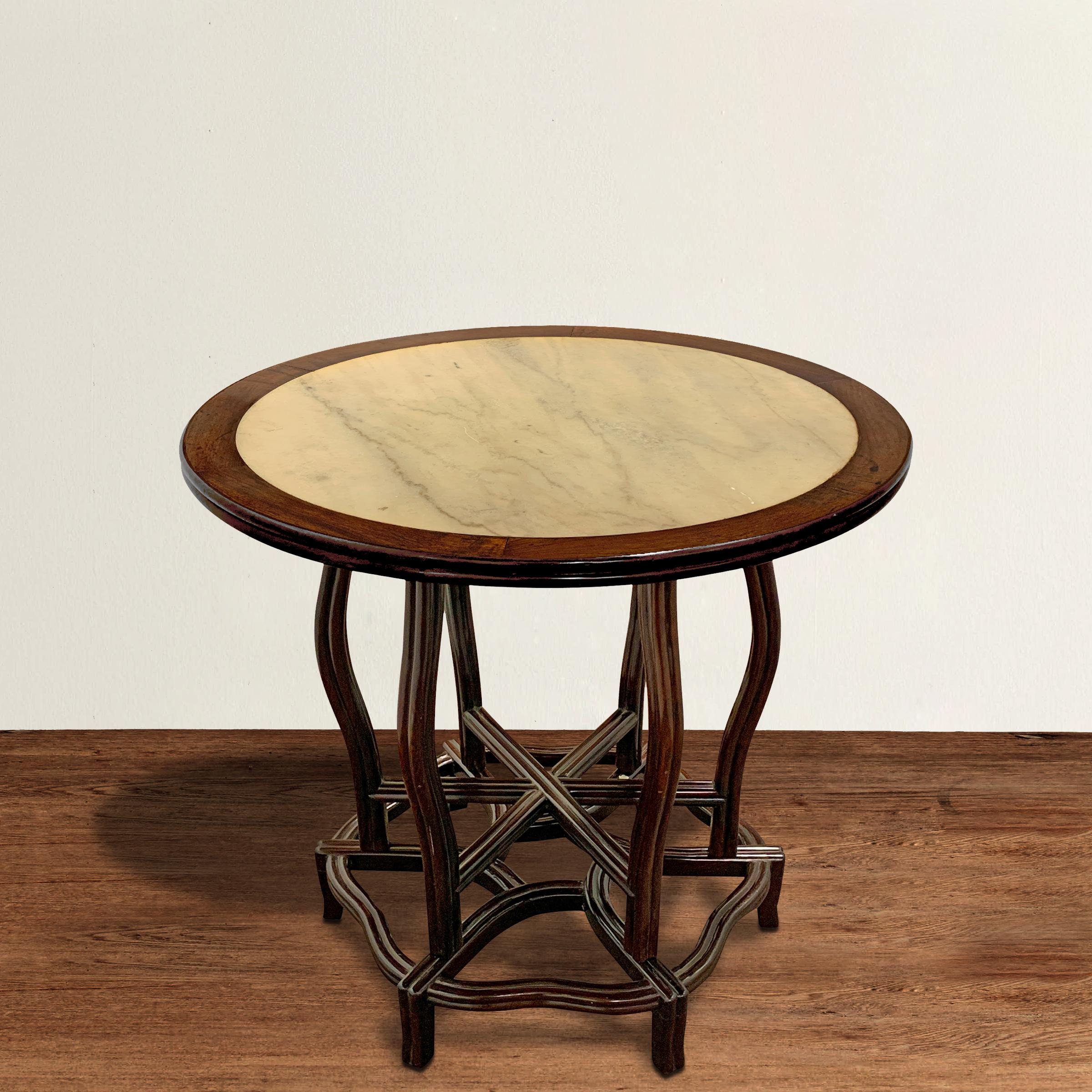 An incredible Chinese Art Deco center table with a rosewood frame designed to mimic a peony, and a marble inset top. The top and base come apart from the central frame to allow for easy transport. This table would be perfect as a center table,
