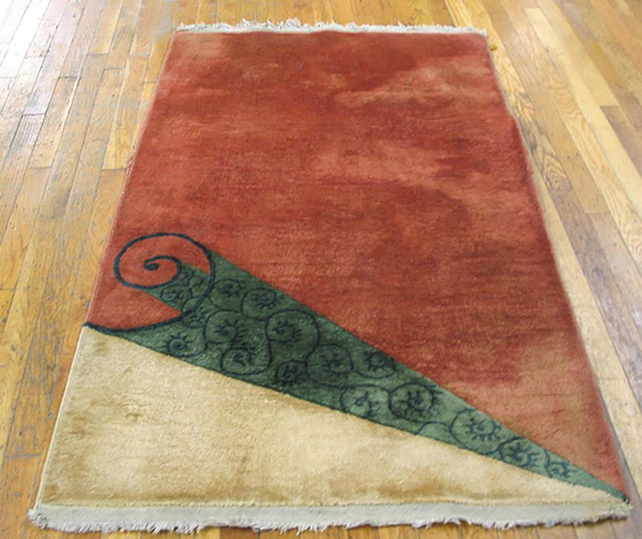 This borderless trompe l’oeil rug displays a soft red scroll rolled back in one corner to revel a scroll 
patterned underside and an ivory triangle beneath. The rug has a three dimensional character.
  