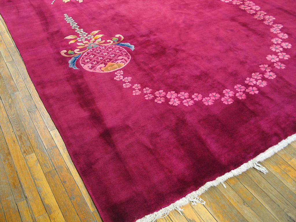 On a borderless raspberry ground a floral spray, attenuates curves and bends under the weight of a colourful pendant. The springy character of the rinceau is evident. This striking 1930s Art Deco Chinese carpet seems to be unique. It is in excellent