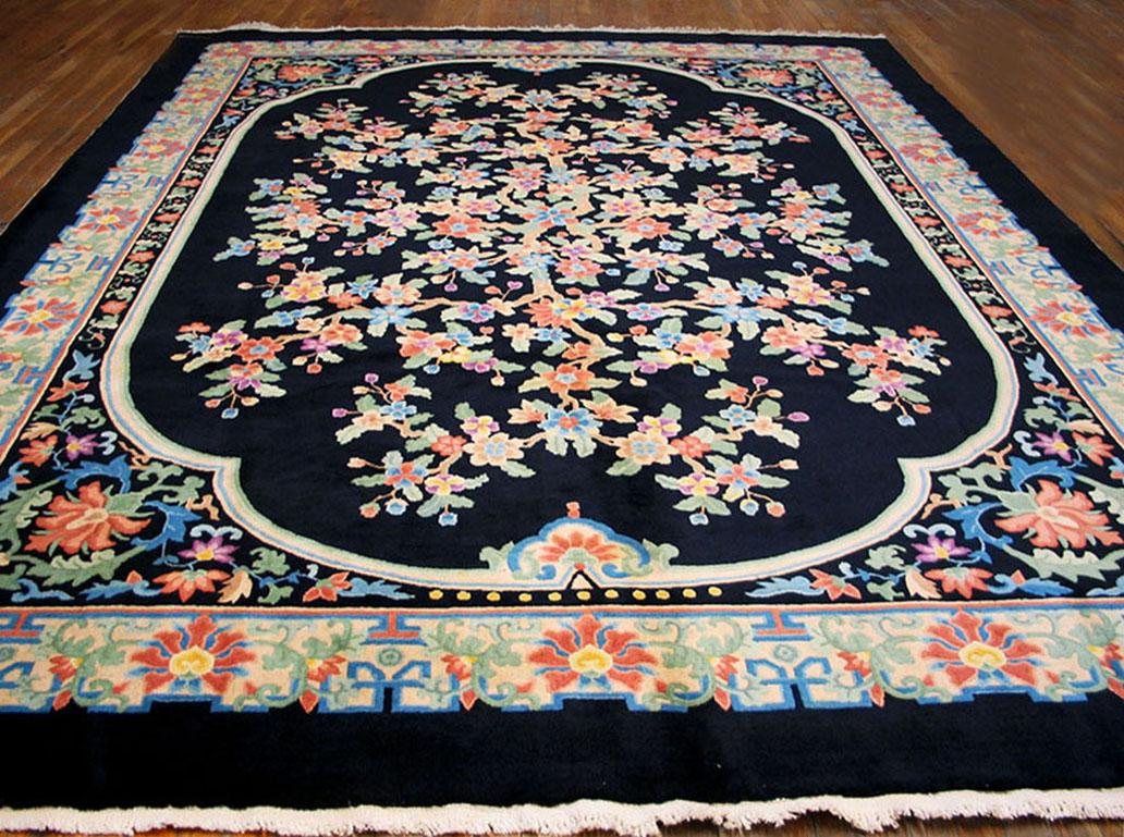The black four lobed field barely contains an explosively flowering, branching major motif. The black palmette and arabesque corners, and the ivory paeony palmette and leafy arabesque main border are in a more stylized manner. This carpet was
