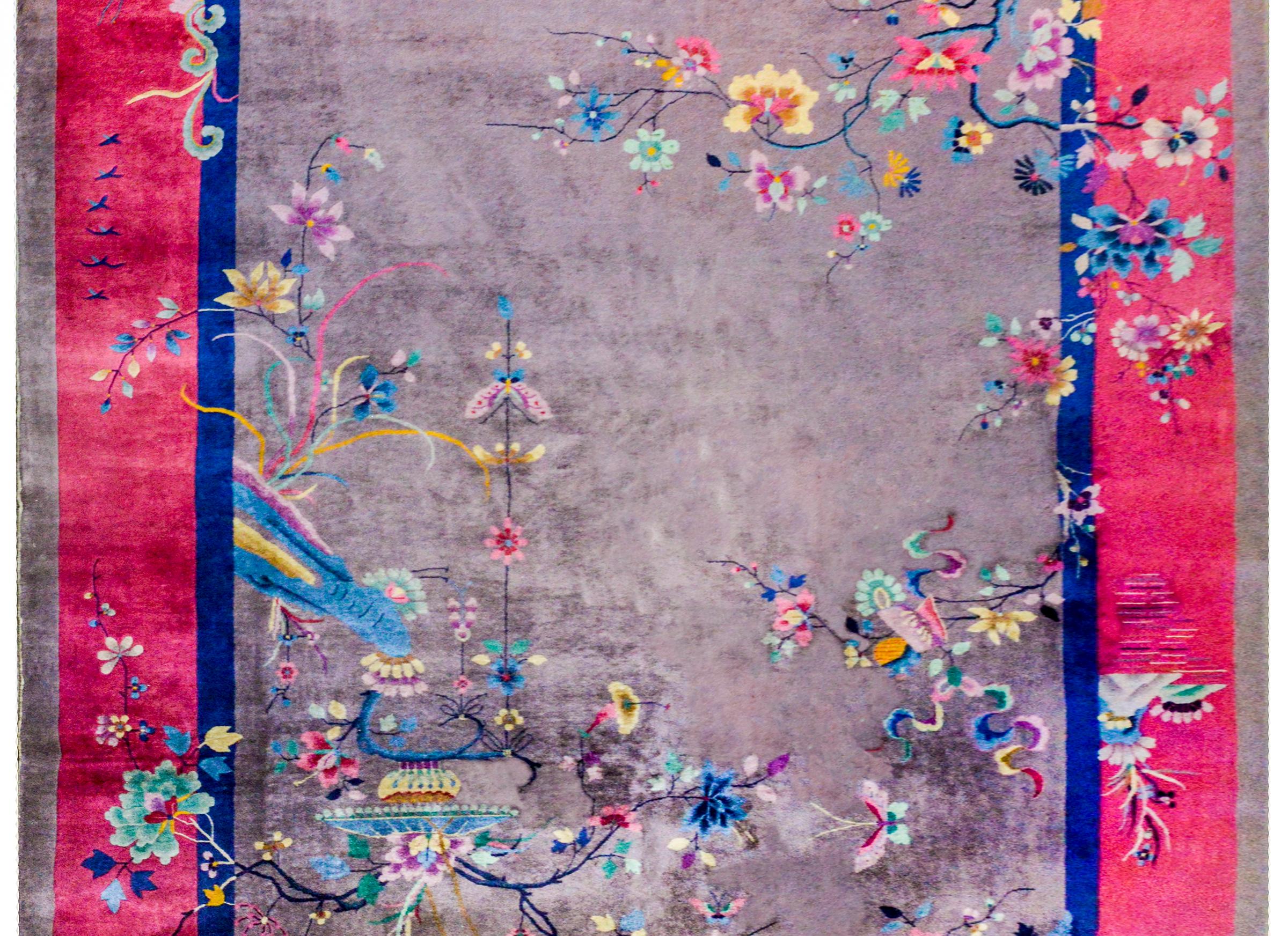 A wonderful early 20th century Chinese Art Deco rug with a fantastic pattern containing an asymmetrical multicolored flowering branches with a hanging lantern, and various birds perched amidst the blooms, on a grey background, surrounded by a wide