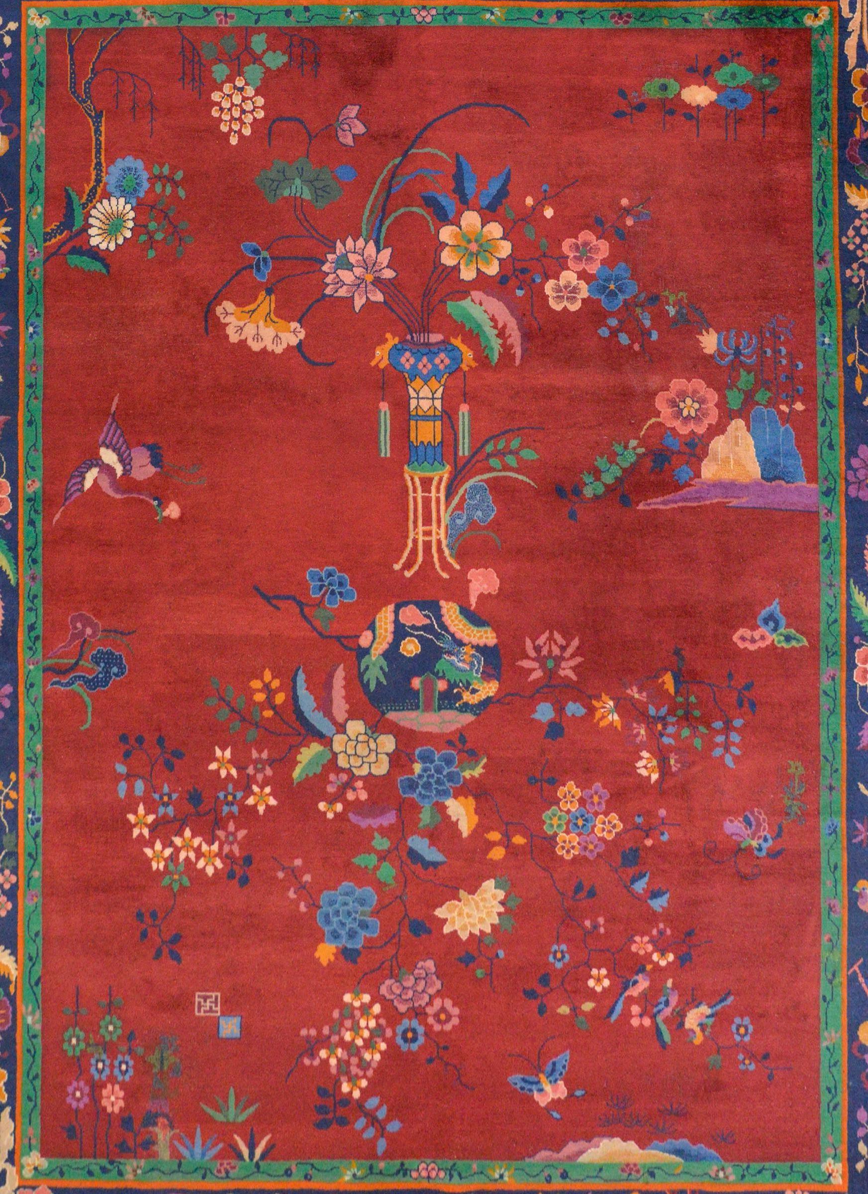An awesome Chinese Art Deco rug with a wonderful pattern containing a vase on stand potted with flowering chrysanthemum, lotus, and prunus blossoms on one side, with a wildly expressive floral pattern on the other, all woven in myriad colors on a