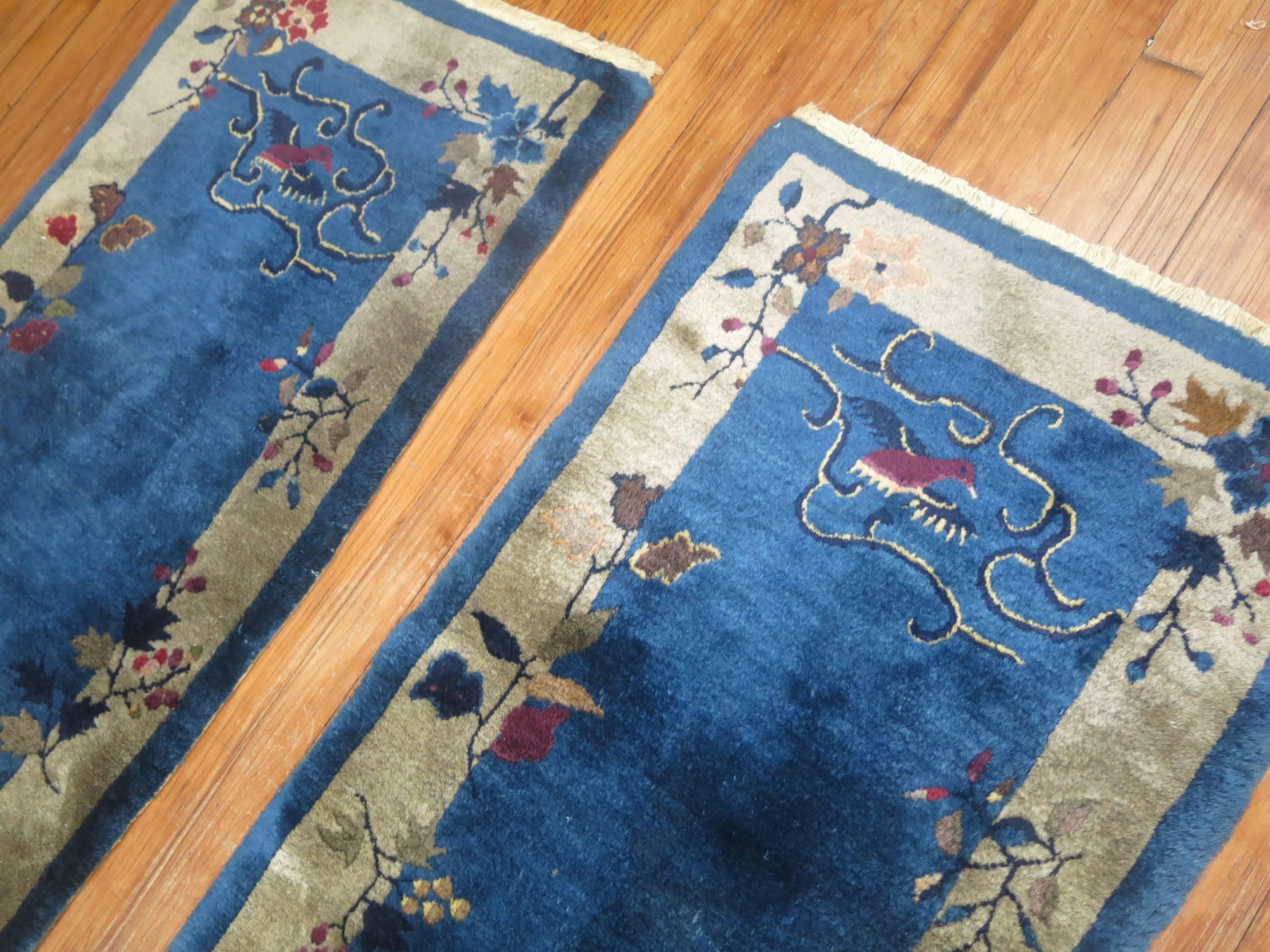 A matching pair of excellent condition full pile Chinese Art Deco rugs in vivid blues. Each measuring 25