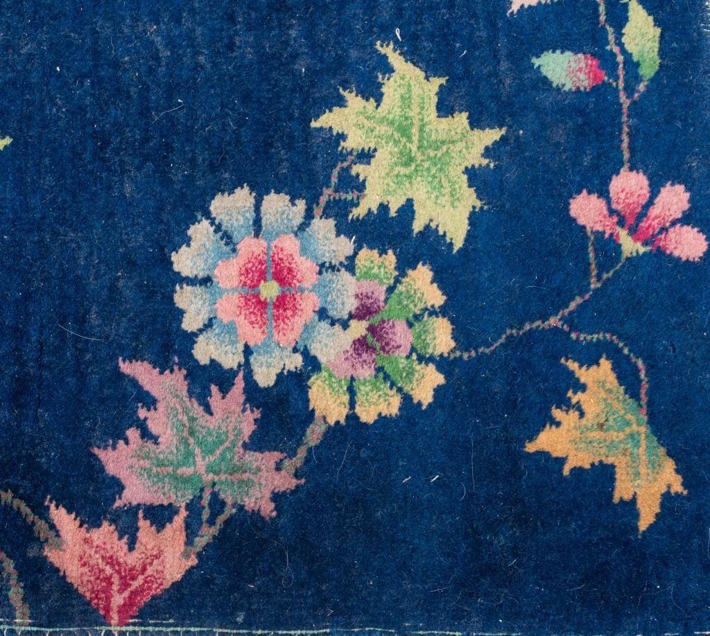 Small Chinese Art Deco carpet with polychrome floral design on a blue ground. 

Dealer: S138XX