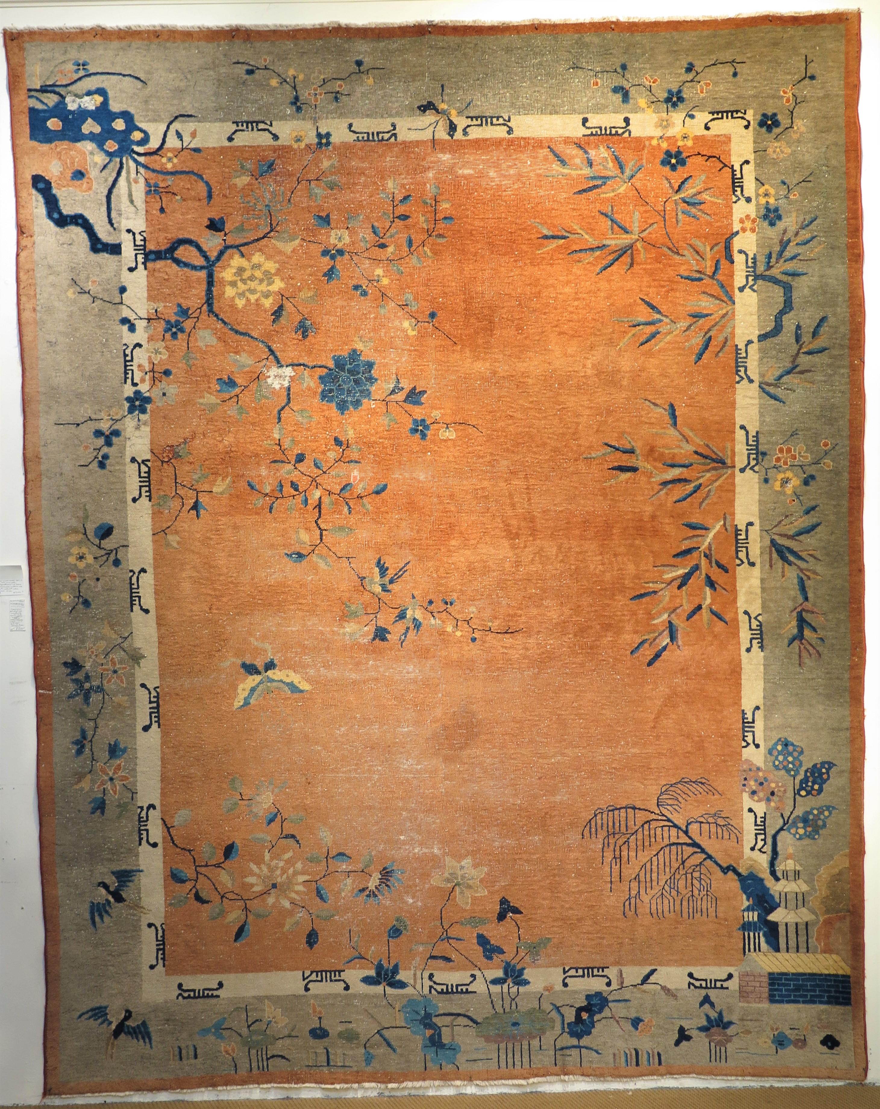 an Art Deco wool area rug / carpet, salmon center with floral decoration and sprigs over the whole. grey border and salmon edge. Chinese characters stylized on border, touches of navy and white. China, circa 1930

several small moth eaten places on