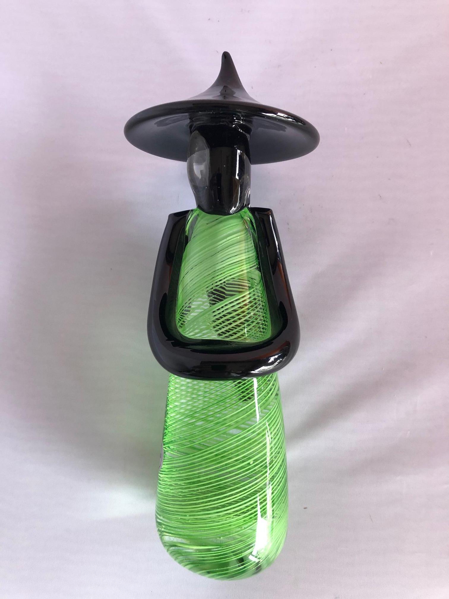 Gorgeous art glass Chinese figurine in green swirl, black and clear Murano glass, circa 1970s. The pieces is signed 