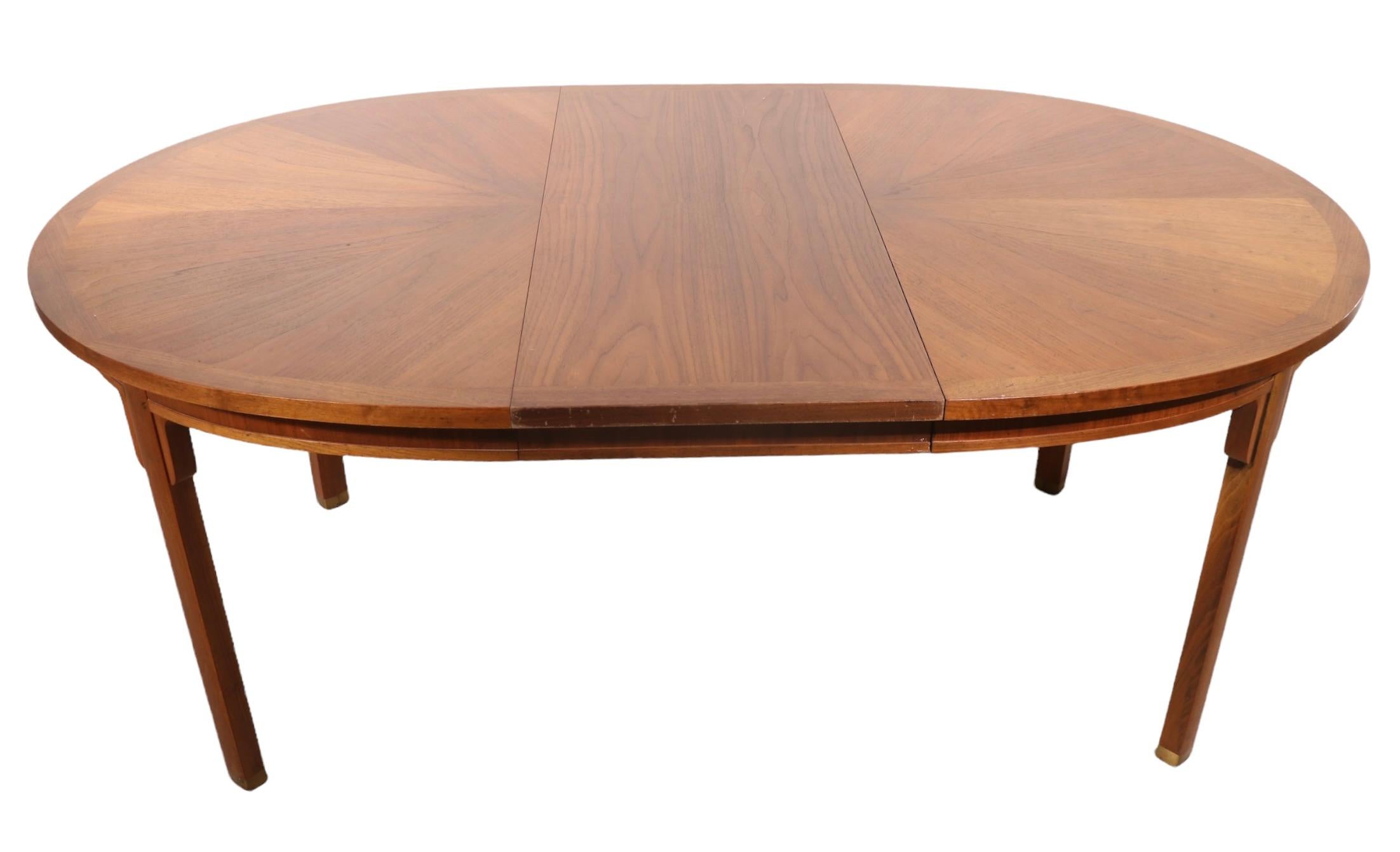 Chic Chinese style dining table by high end American furniture maker , Baker, from their Milling Road division. The table comes with three large ( 18 in. W each ), allowing it to be extended from the closed position ( 54.2 in. W ) to the open 
 (