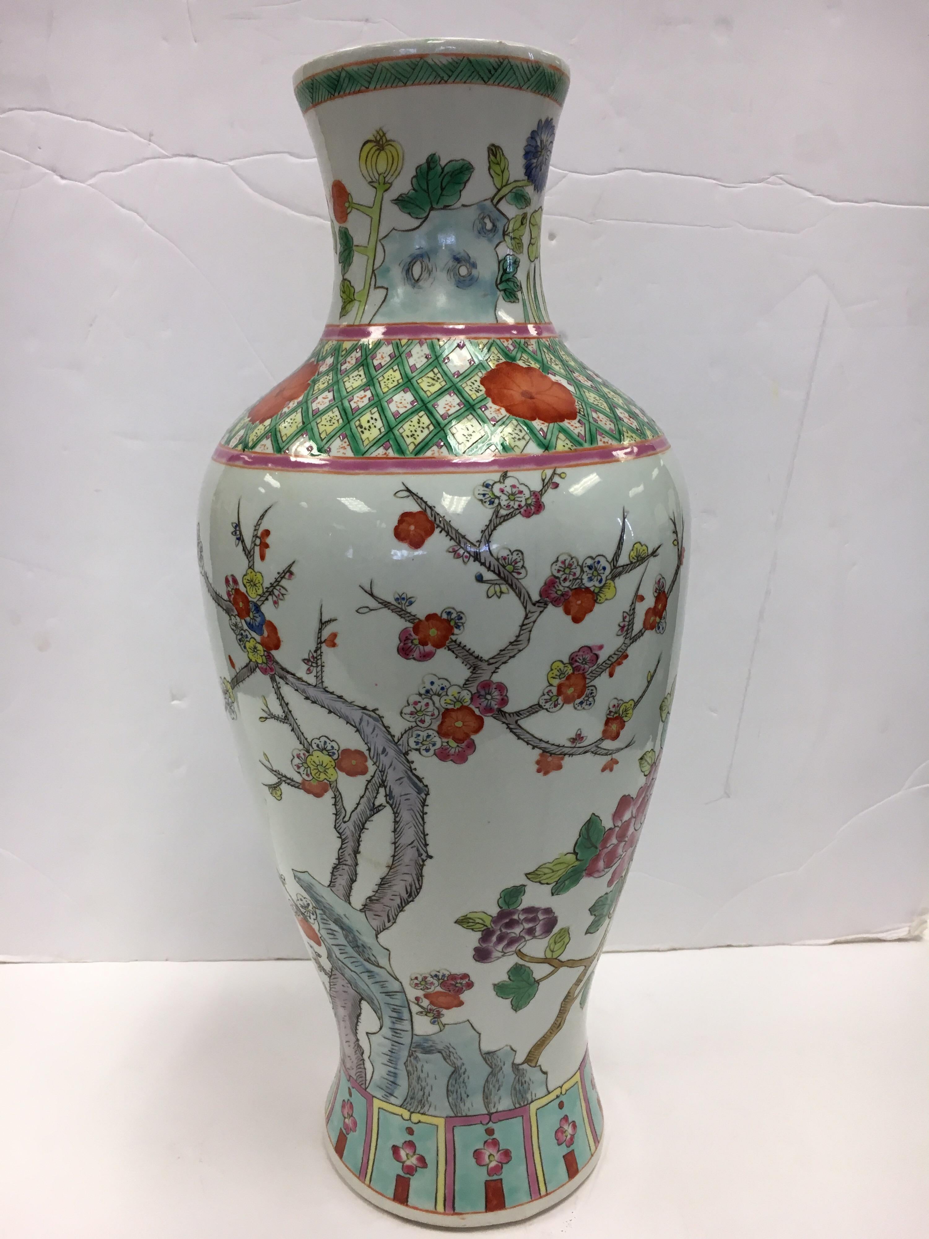 Stunning Chinese baluster form vintage vase with hand painted flowers, trees and branches.
The colors are vivid and vibrant.